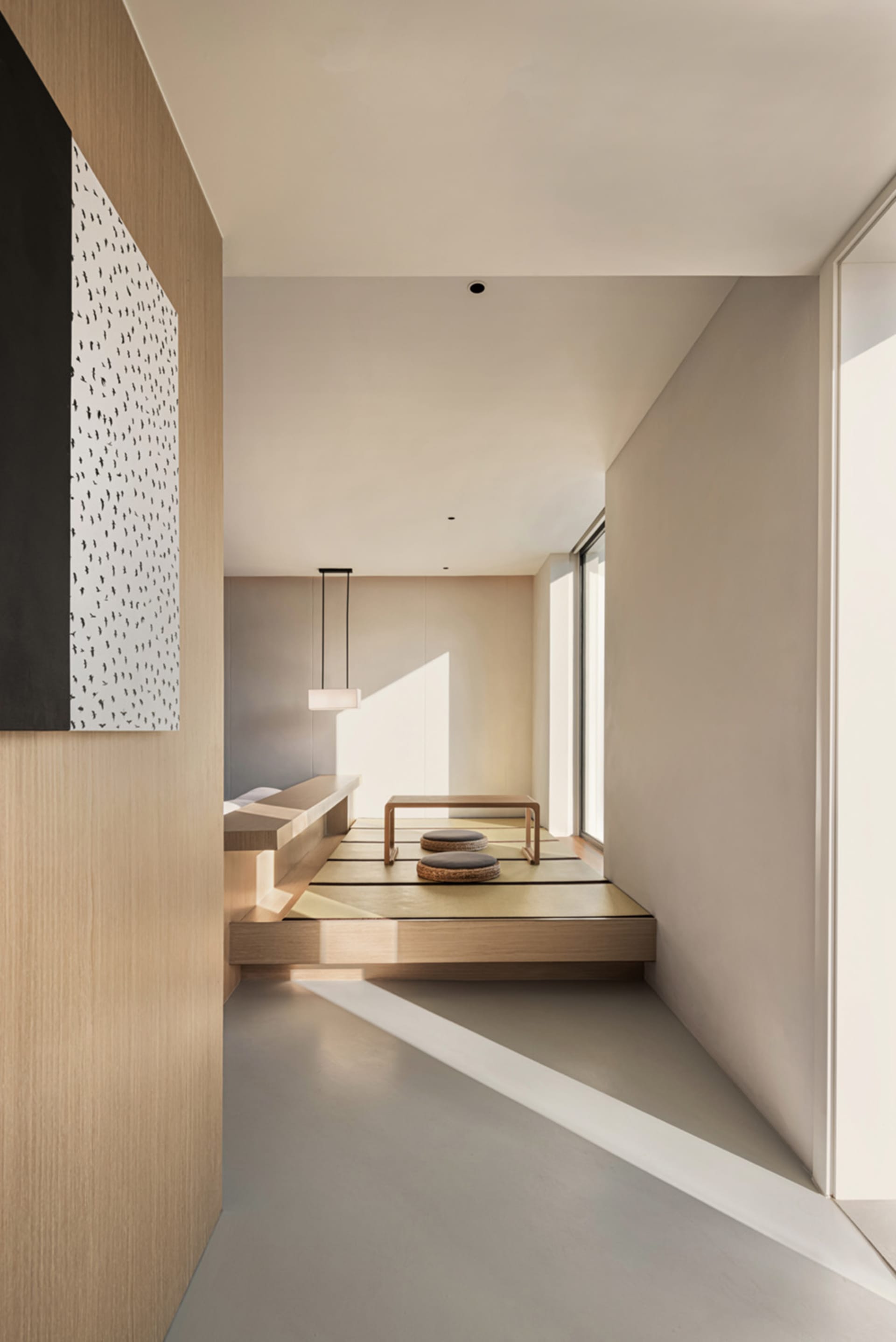 A modern minimalist living space with wooden accents and beige tiles