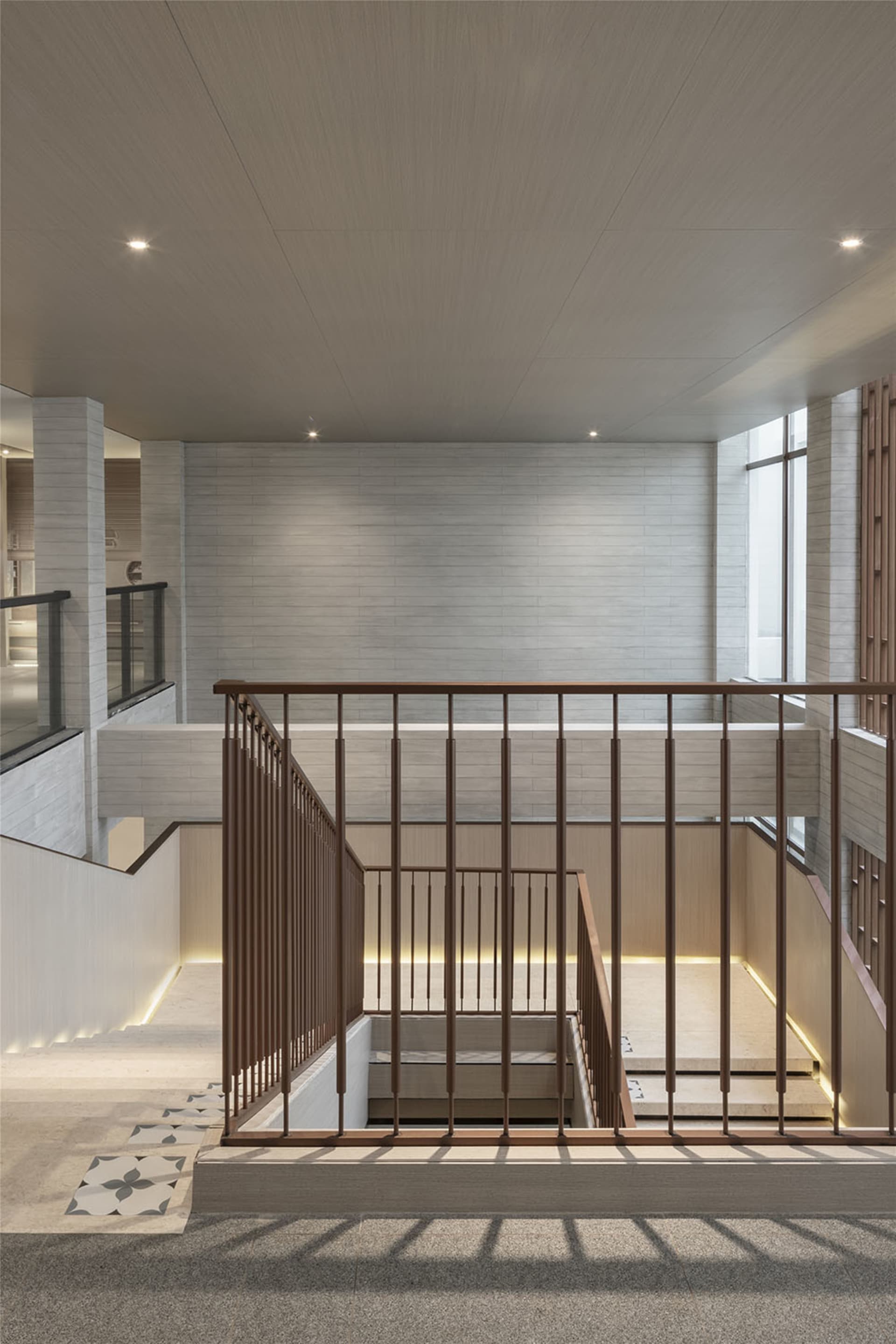 Modern staircase with concrete treads and wooden railings.
