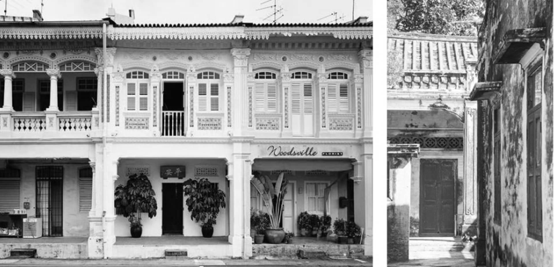 Historic residential building with concrete and brick facade, traditional architectural details, potted plants in front.