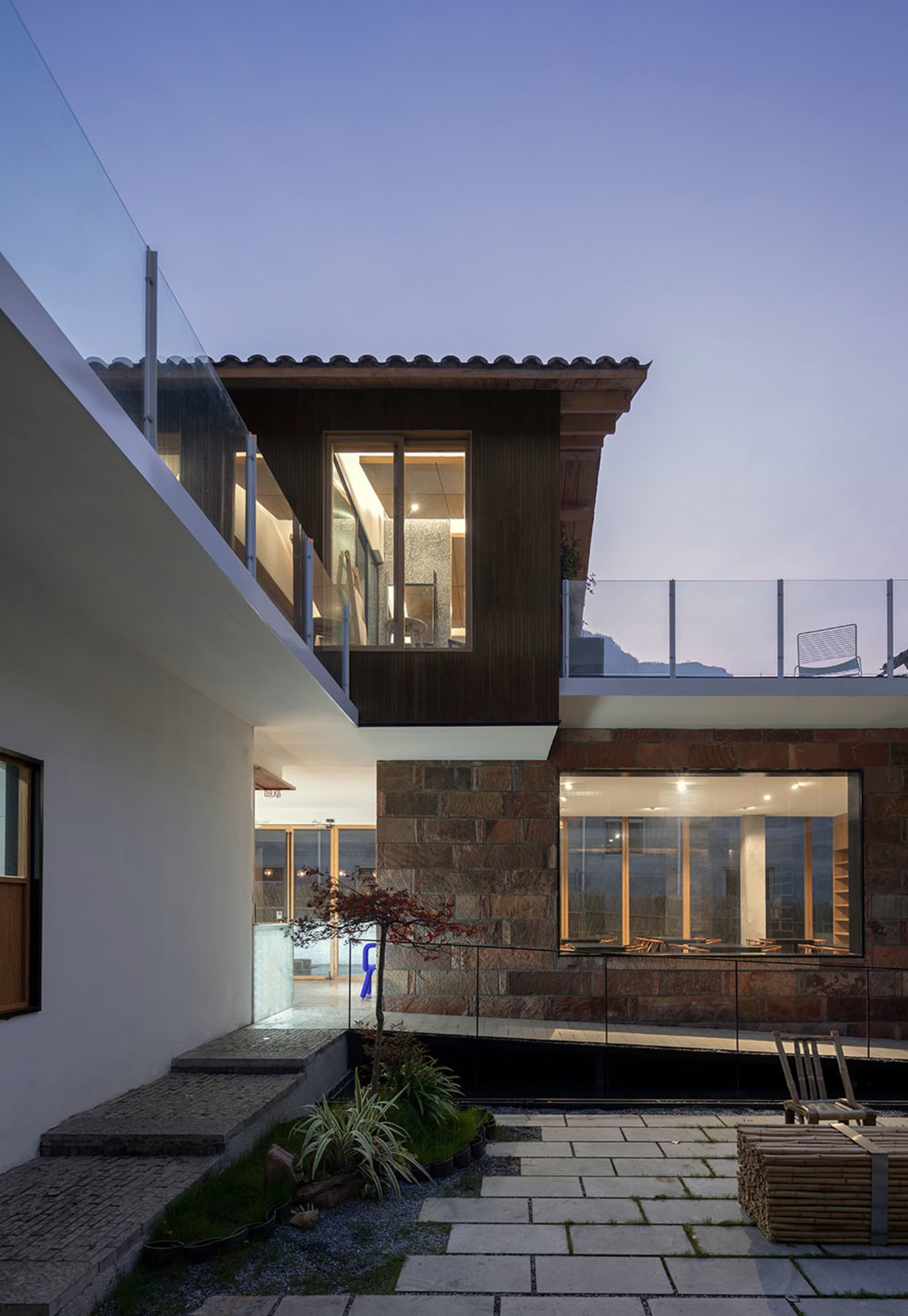 Modern residential exterior with glass and brick materials.
