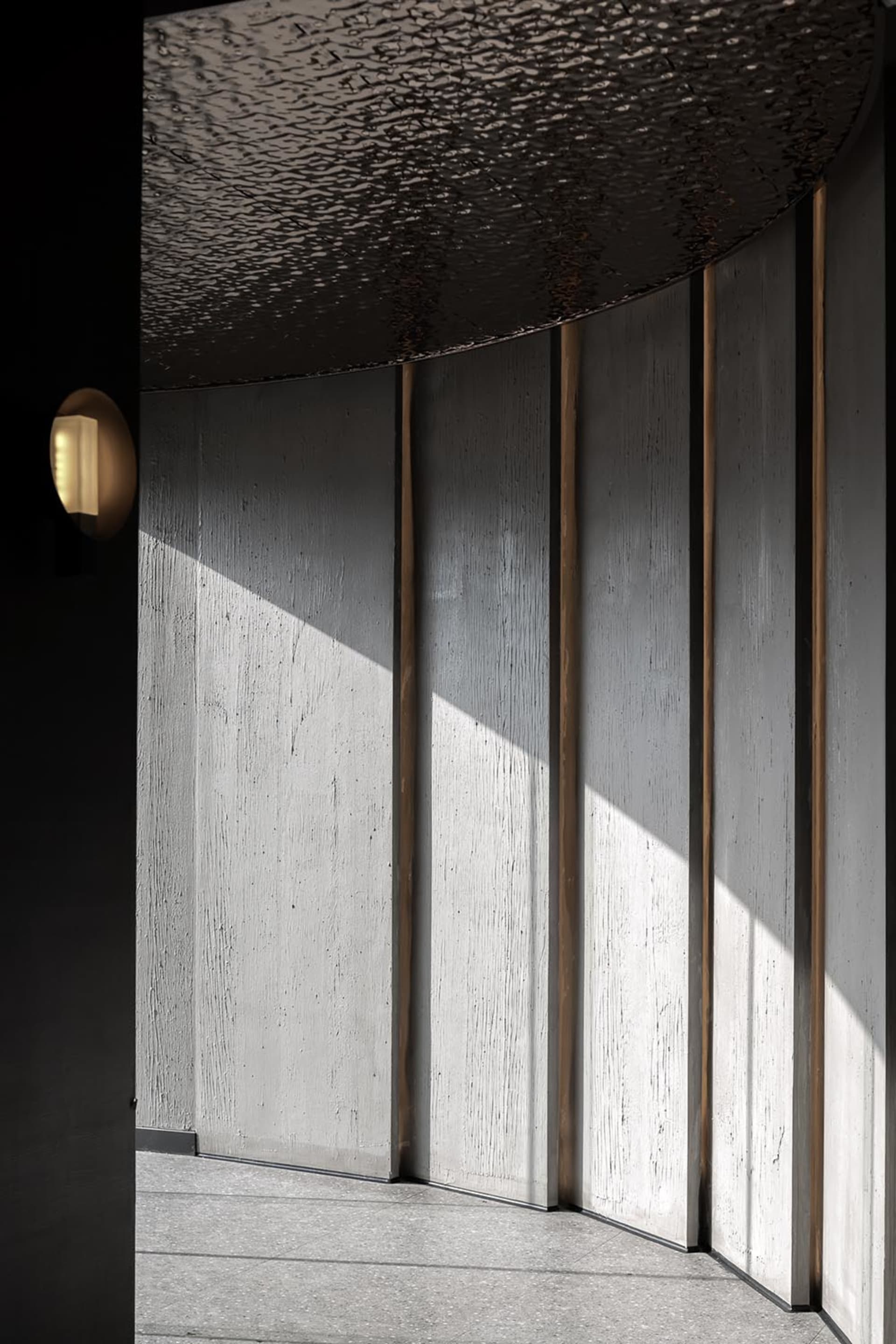 Modern interior space featuring concrete walls and lighting
