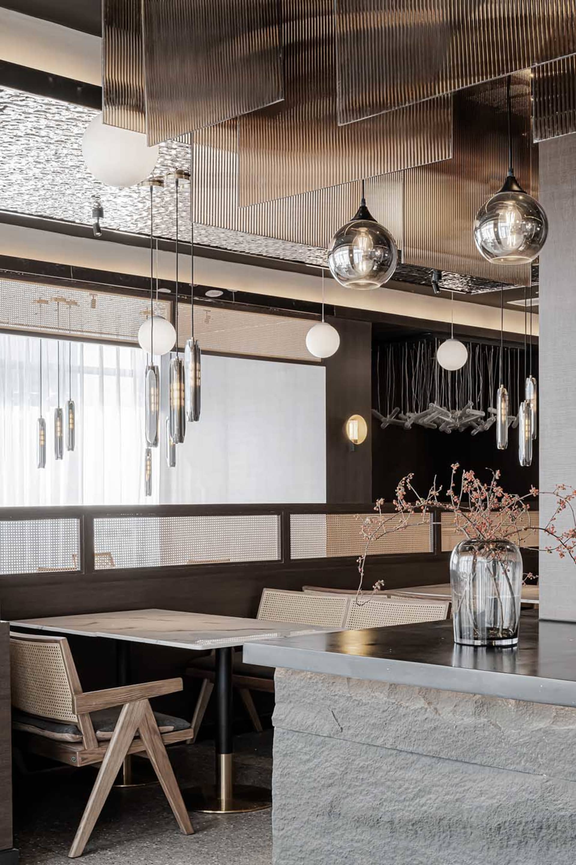 Modern restaurant interior with concrete and glass materials.