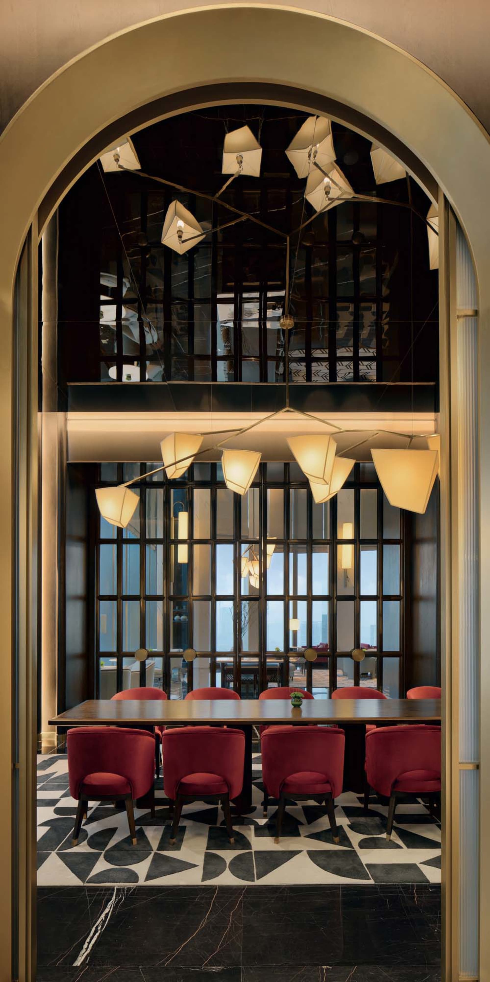 A modern restaurant interior featuring mixed materials, with a focus on the dining area and unique lighting fixtures.