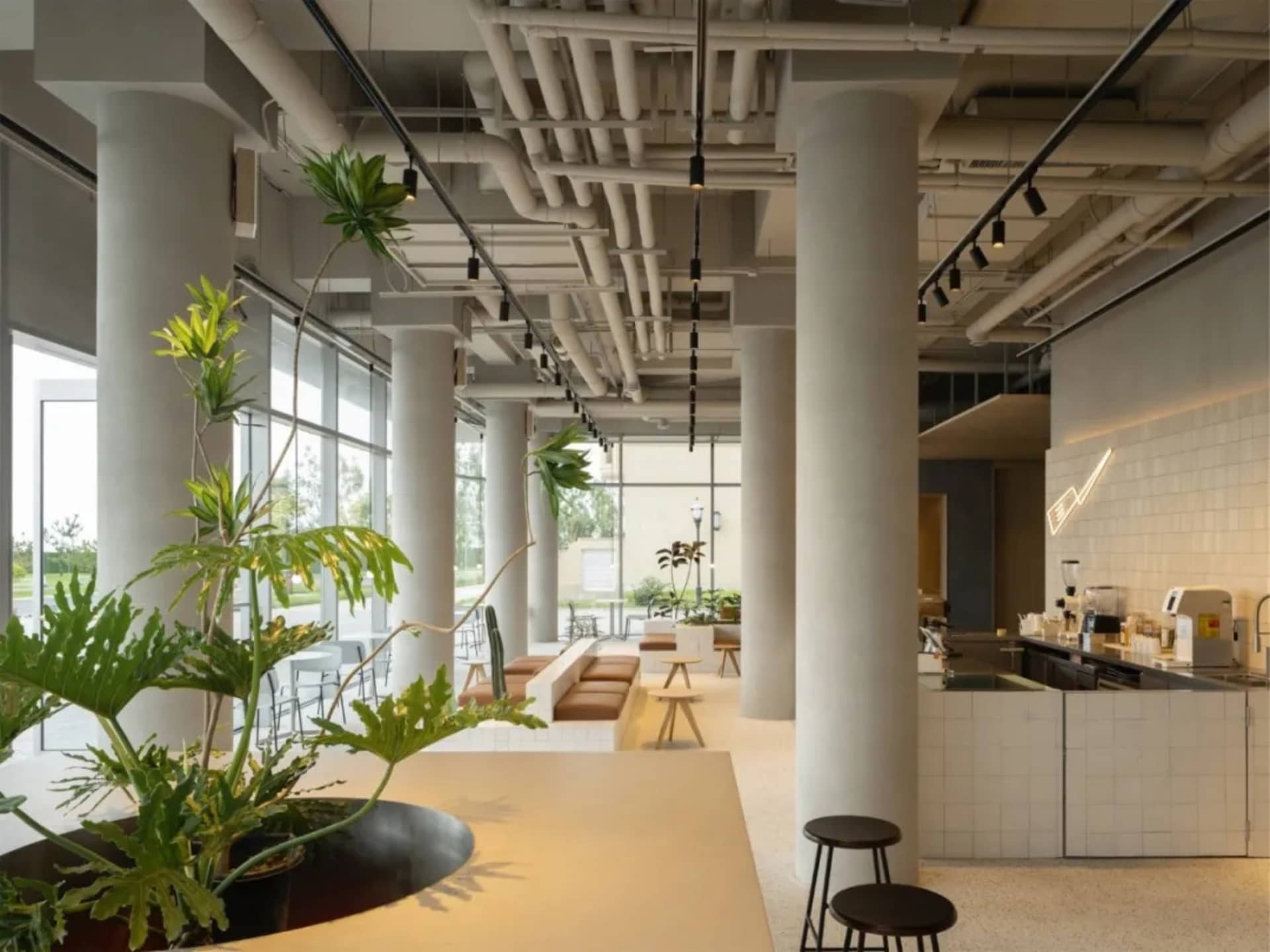 Modern café interior with industrial style, featuring concrete materials and minimalist design.