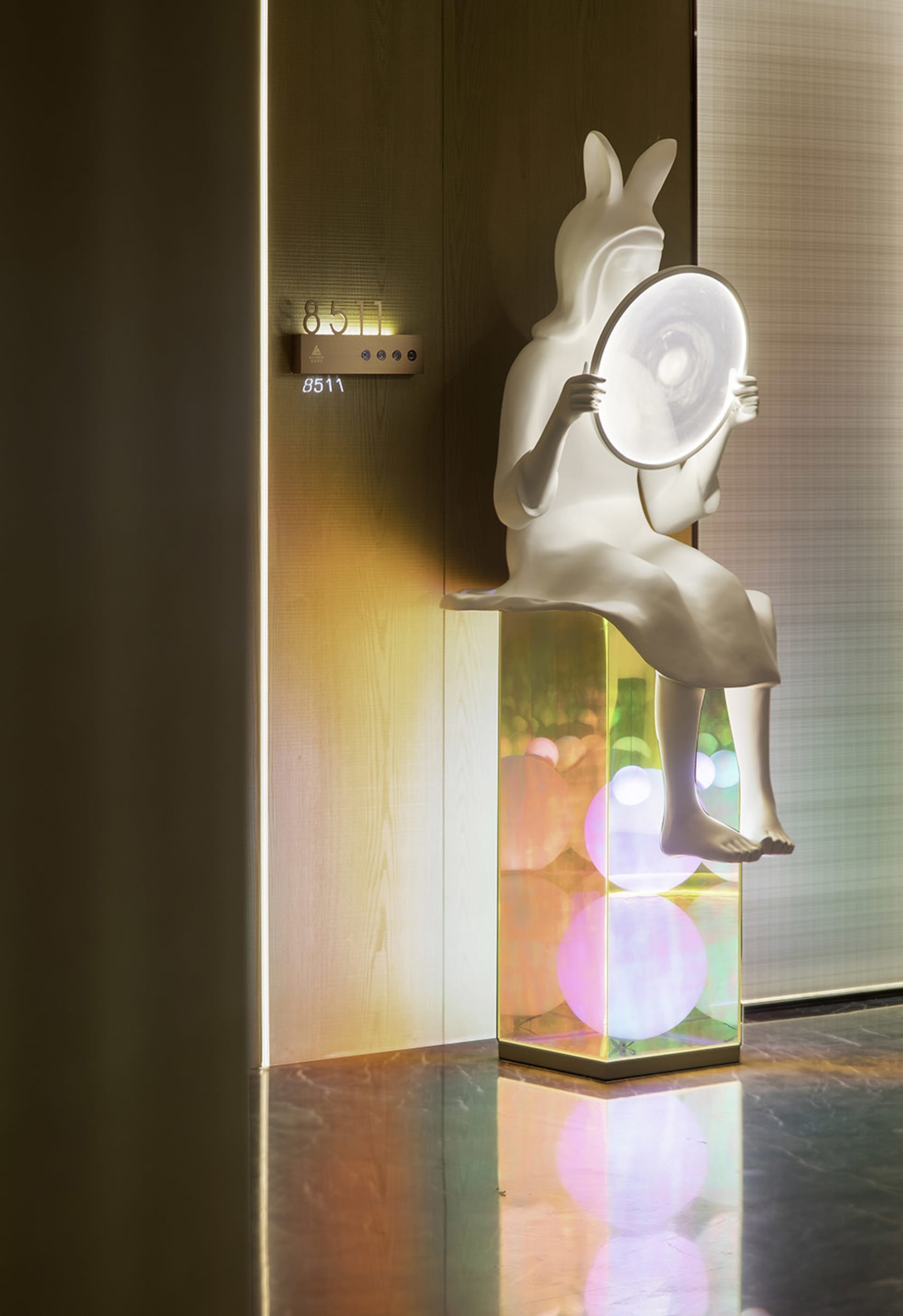 A modern interior design featuring glass lighting fixtures and futuristic lighting effects.