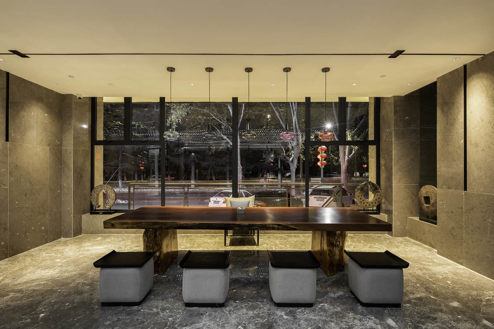 A modern lobby interior designed with concrete elements, featuring minimalist aesthetics and sleek furniture.