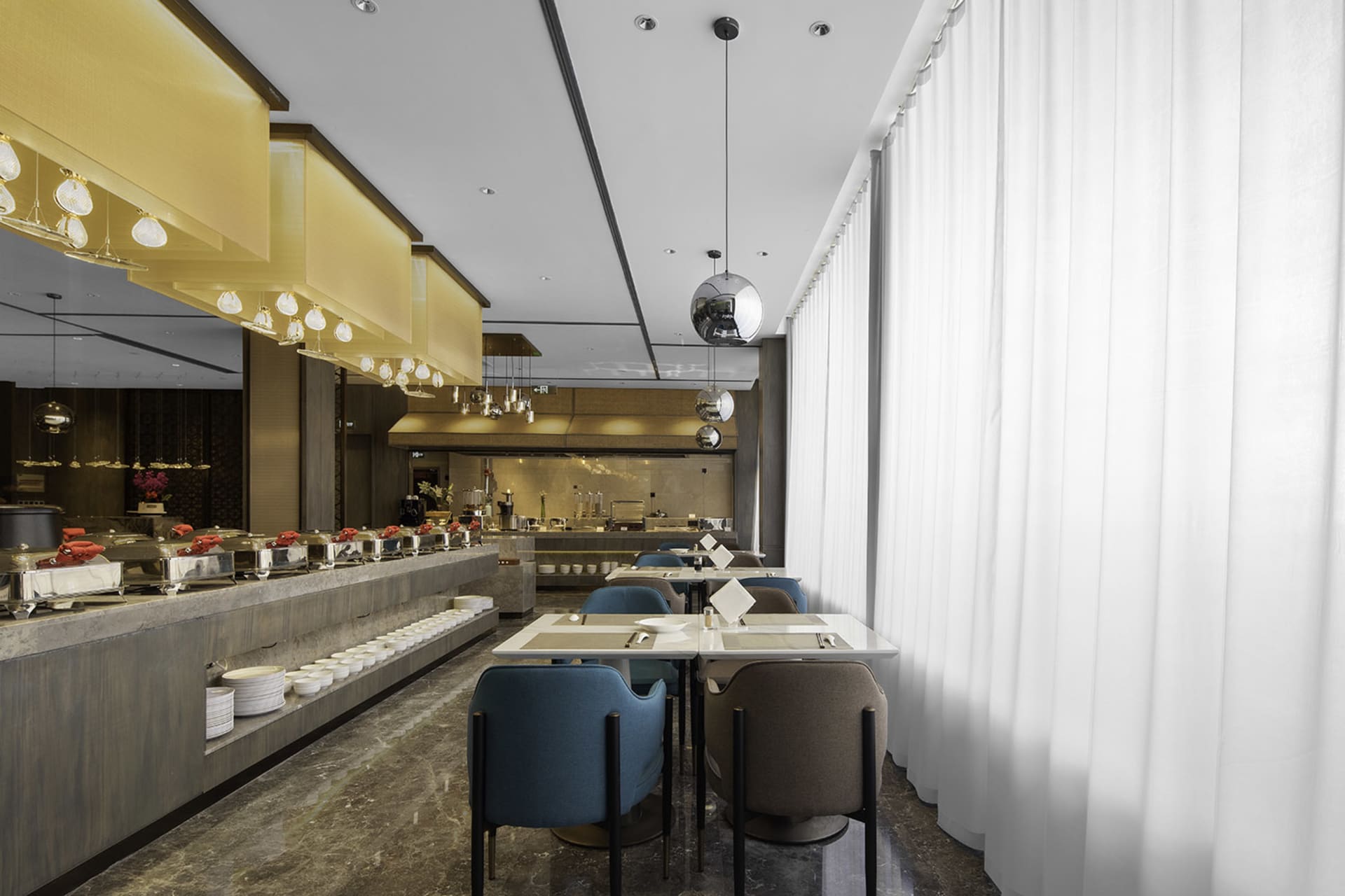 Modern restaurant interior with marble and concrete finishes, showcasing contemporary design elements.