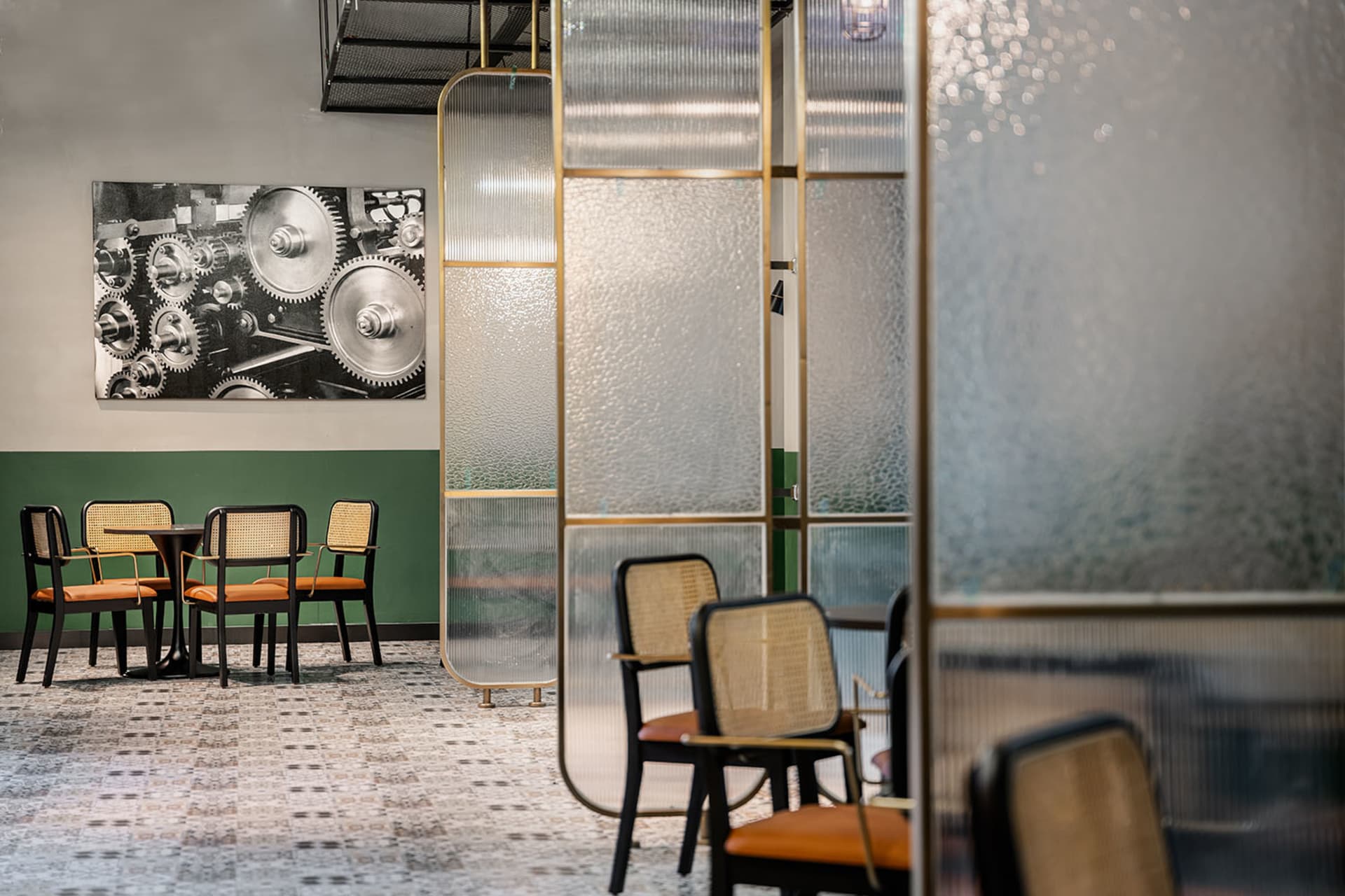 Modern industrial-style cafe interior featuring metal and glass materials