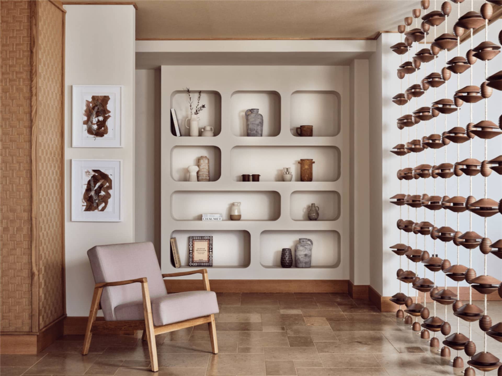 A minimalist interior space featuring wooden furniture and ceramic decor items on shelves.