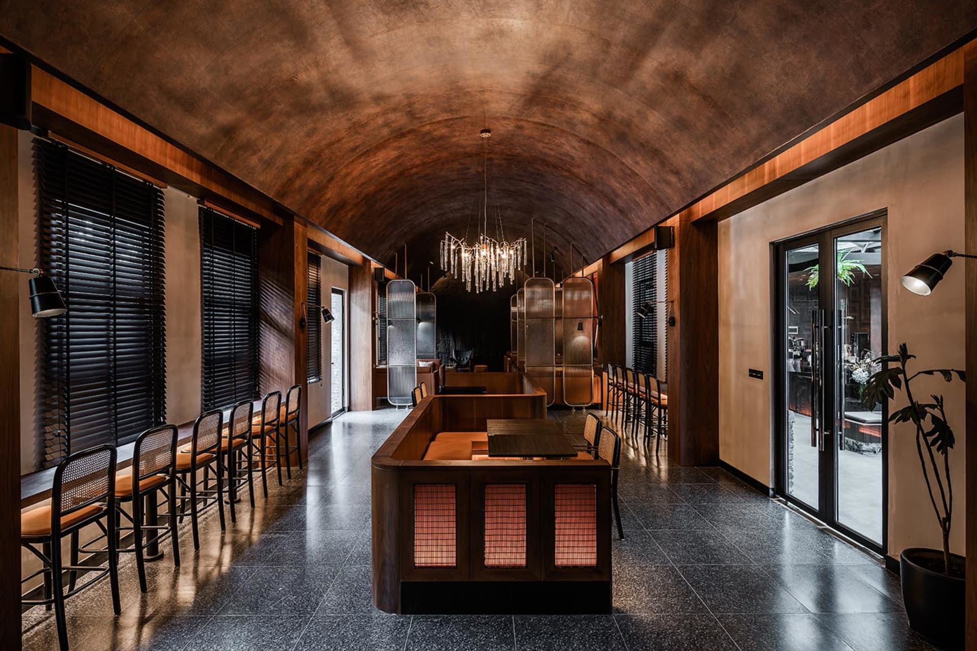 A modern cafe interior with metal, wood, and glass materials.