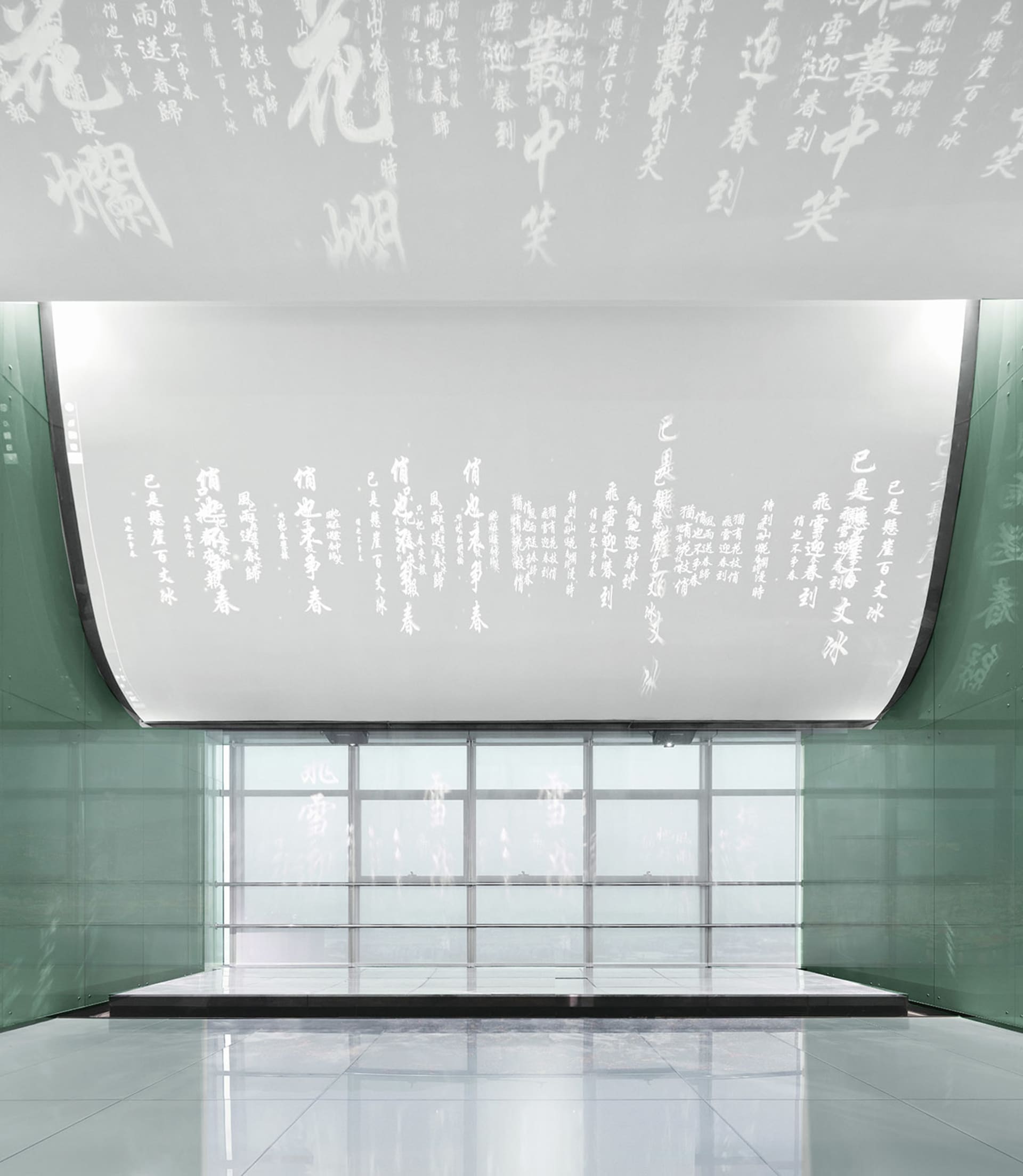 A modern lobby featuring glass walls and a minimalist design.