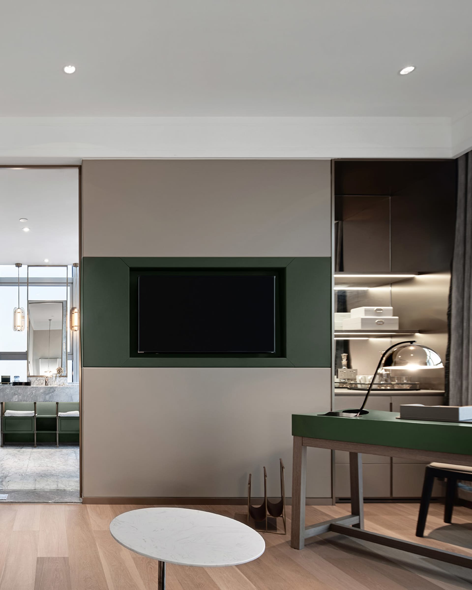 A modern residential kitchen featuring sleek, dark teak cabinetry and a contemporary design aesthetic.