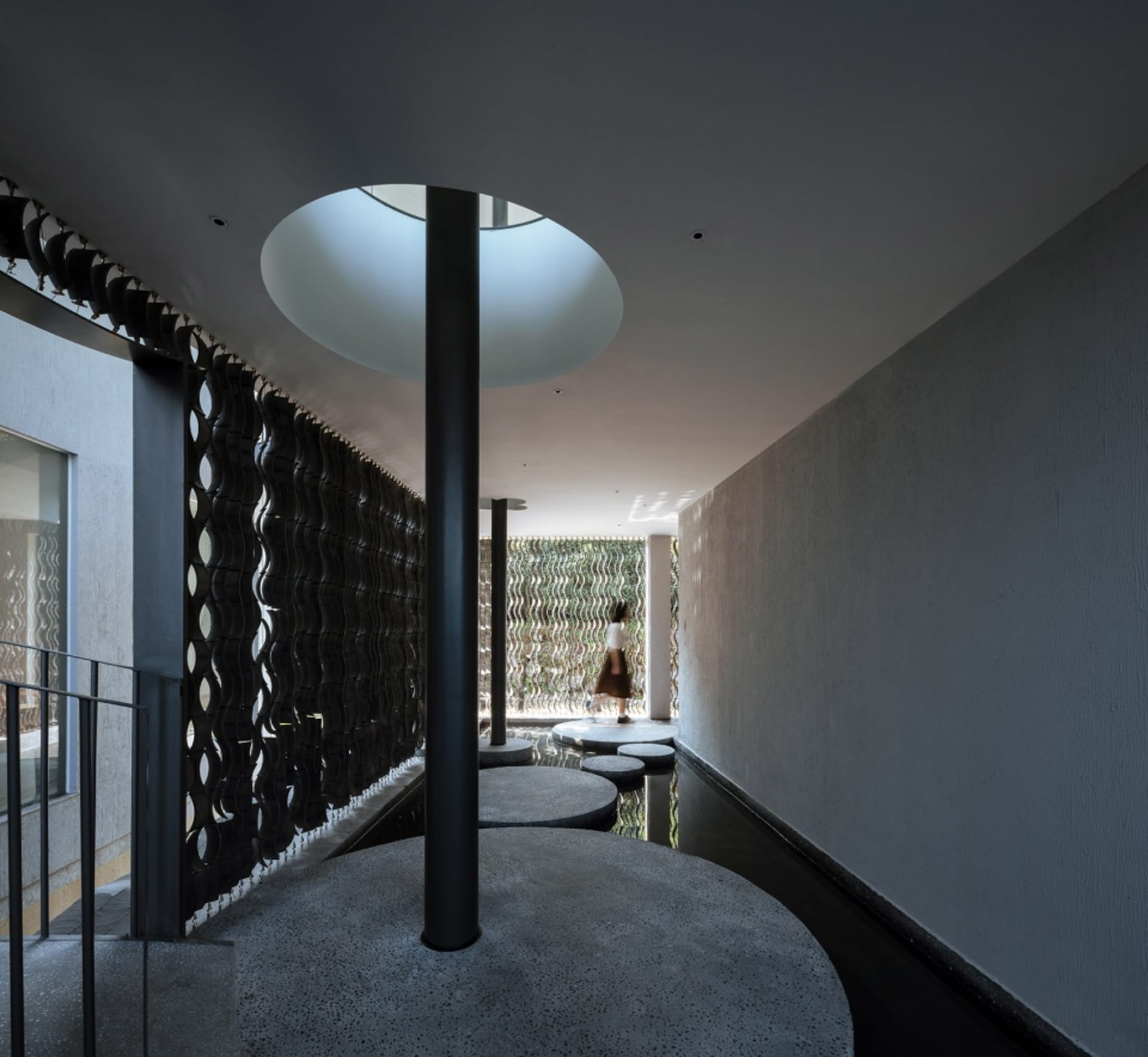 A modern interior design featuring a combination of concrete and glass materials.