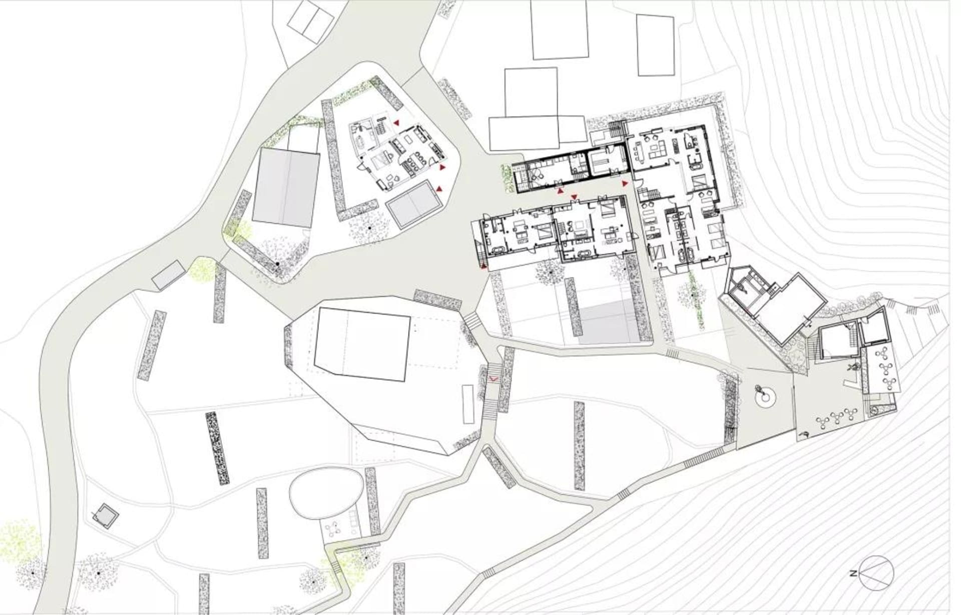Floor plan of a modern residential building with various rooms and outdoor spaces.