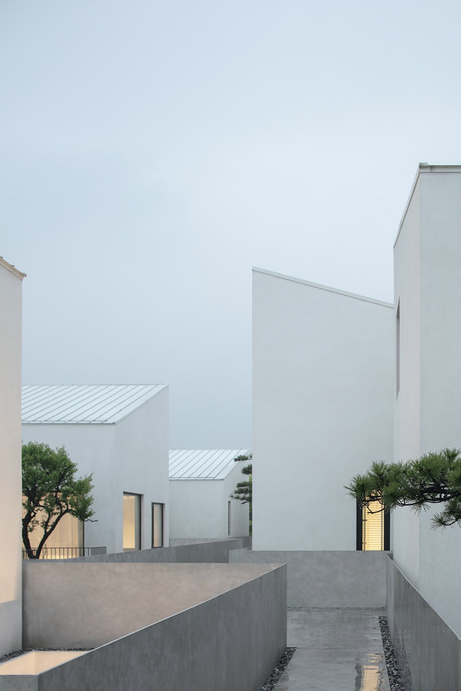 A minimalist white building made of concrete material.