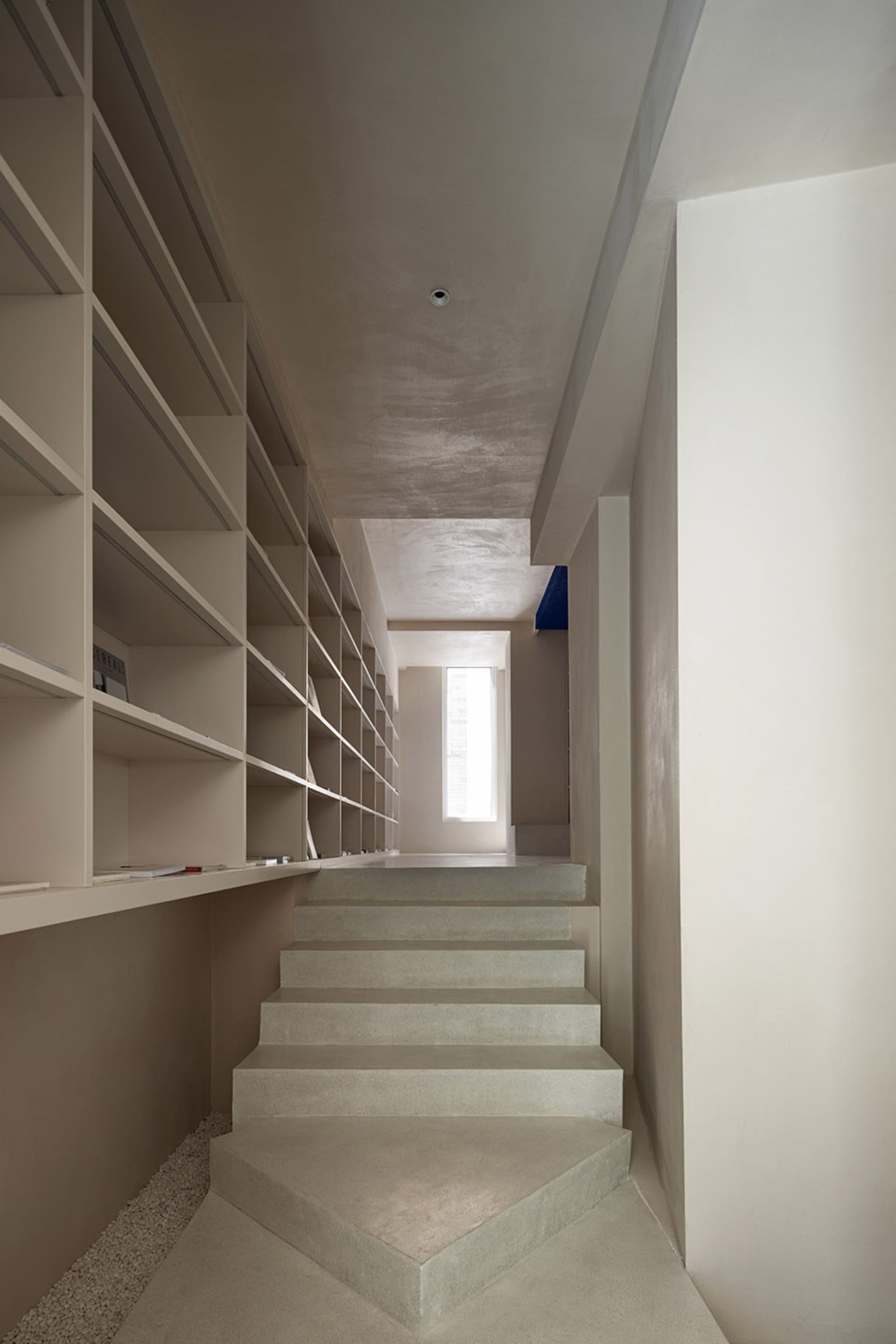Modern concrete staircase interior with minimalistic design and natural lighting.
