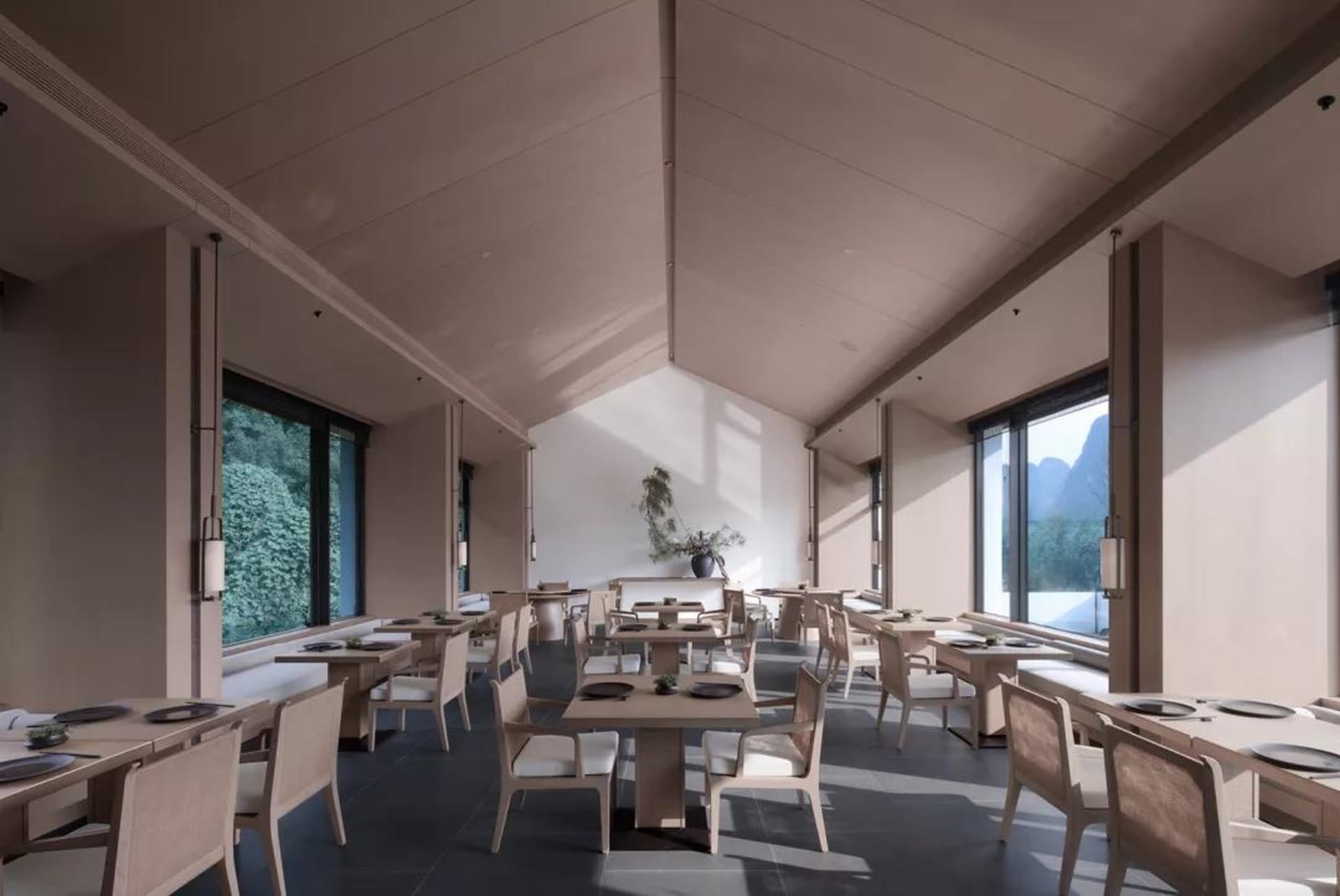 Modern restaurant interior with concrete finishes, white chairs, and large windows.