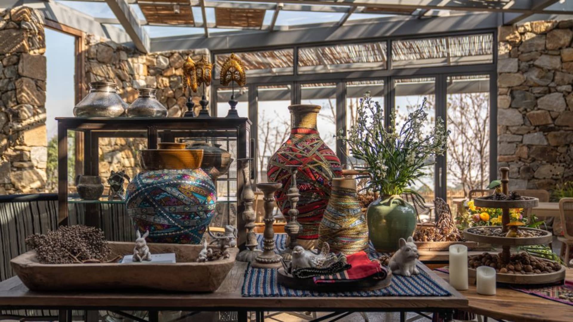 A collection of decorative ceramic and metallic objects on a table.