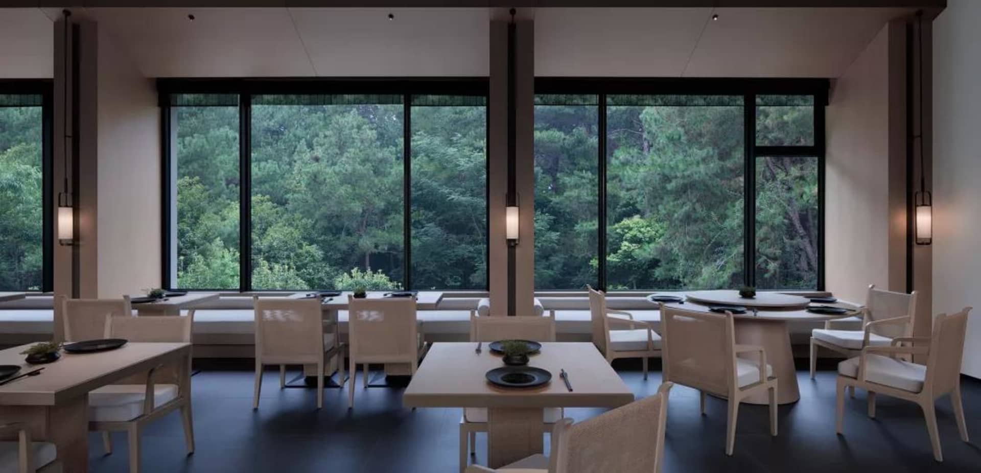 A restaurant interior featuring white wood furnishings, animal skin accents, and a marble counter.