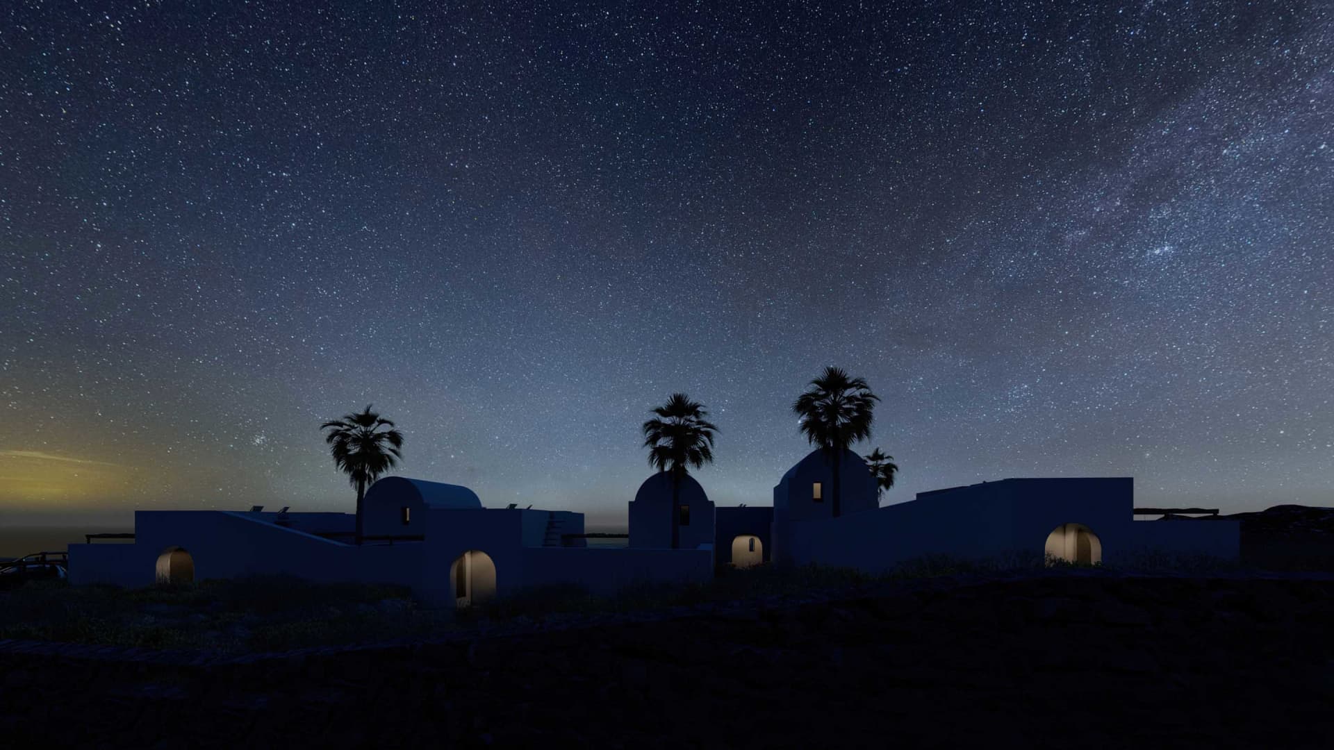 Standing on the hill overlooking the stars, a modern vacation retreat with concrete archways leads guests toward lush palms a