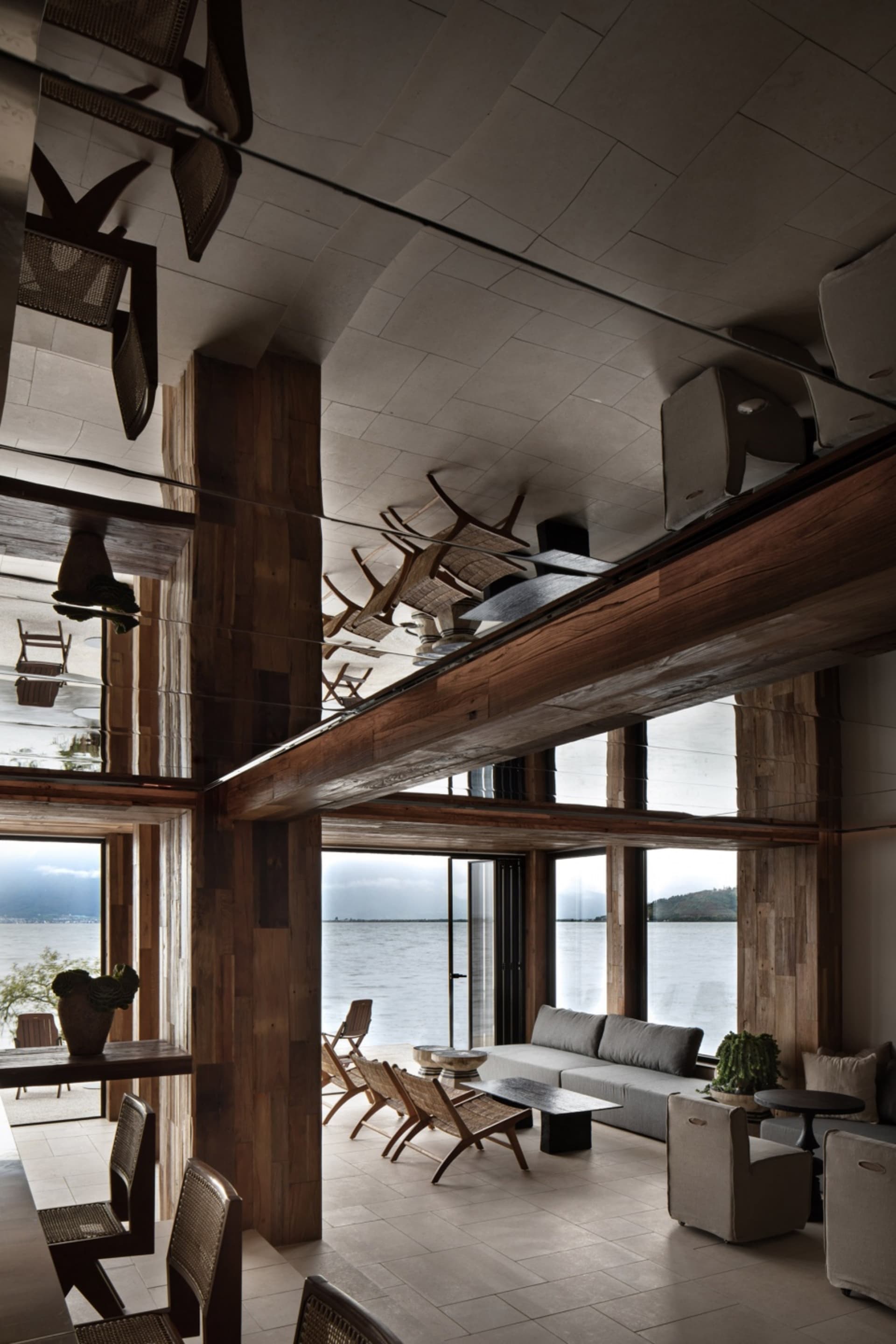 Modern living room interior design with wooden furniture and a view of the ocean.