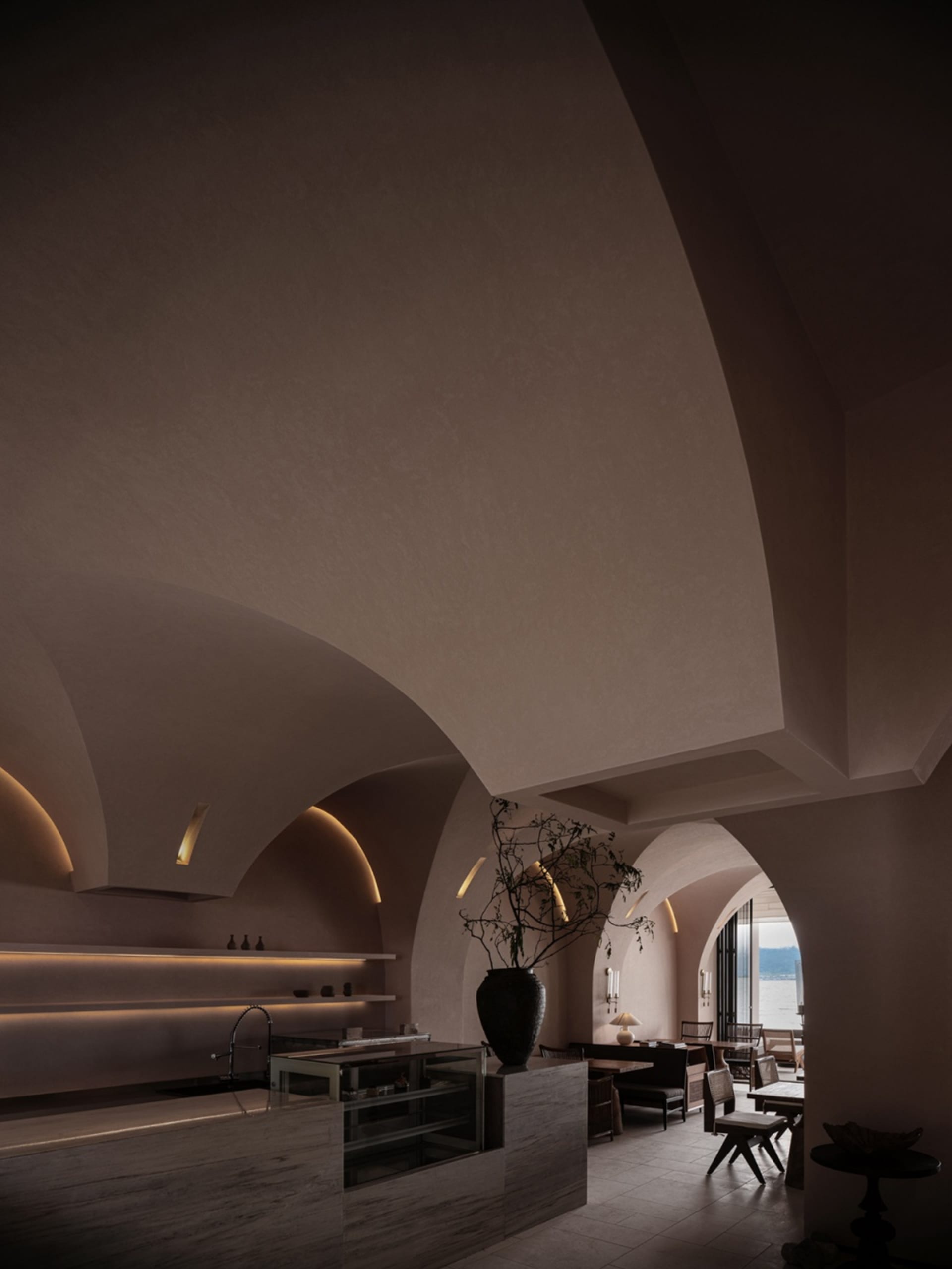Interior design of a modern restaurant lobby with concrete walls and ambient lighting.