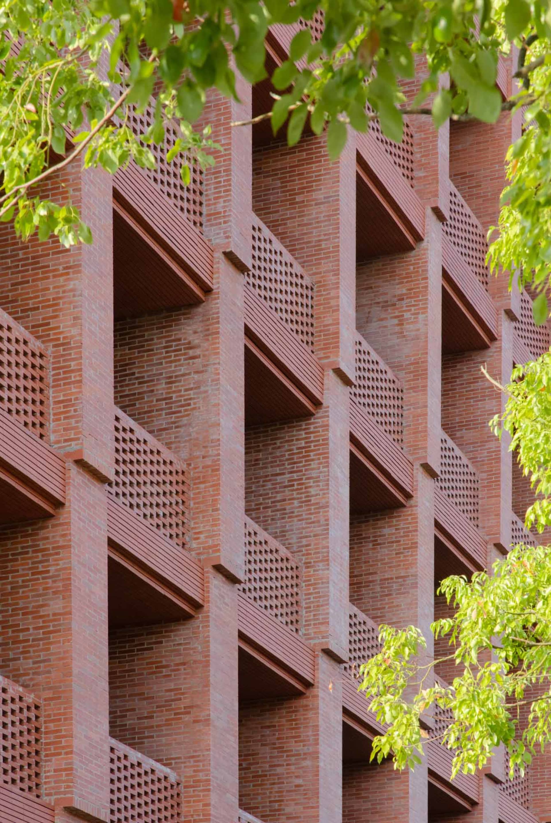 Modern brick building exterior with geometric design patterns.