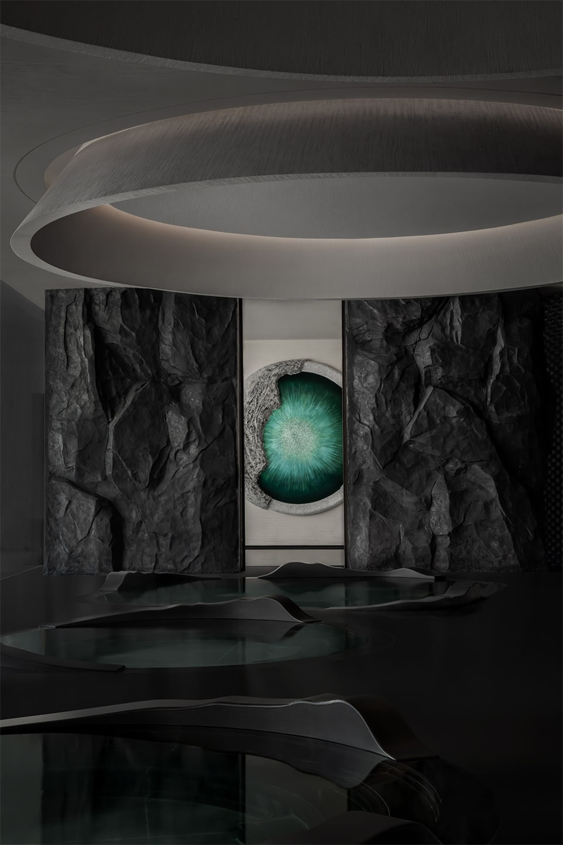 A modern interior space featuring concrete, stone, and glass materials.