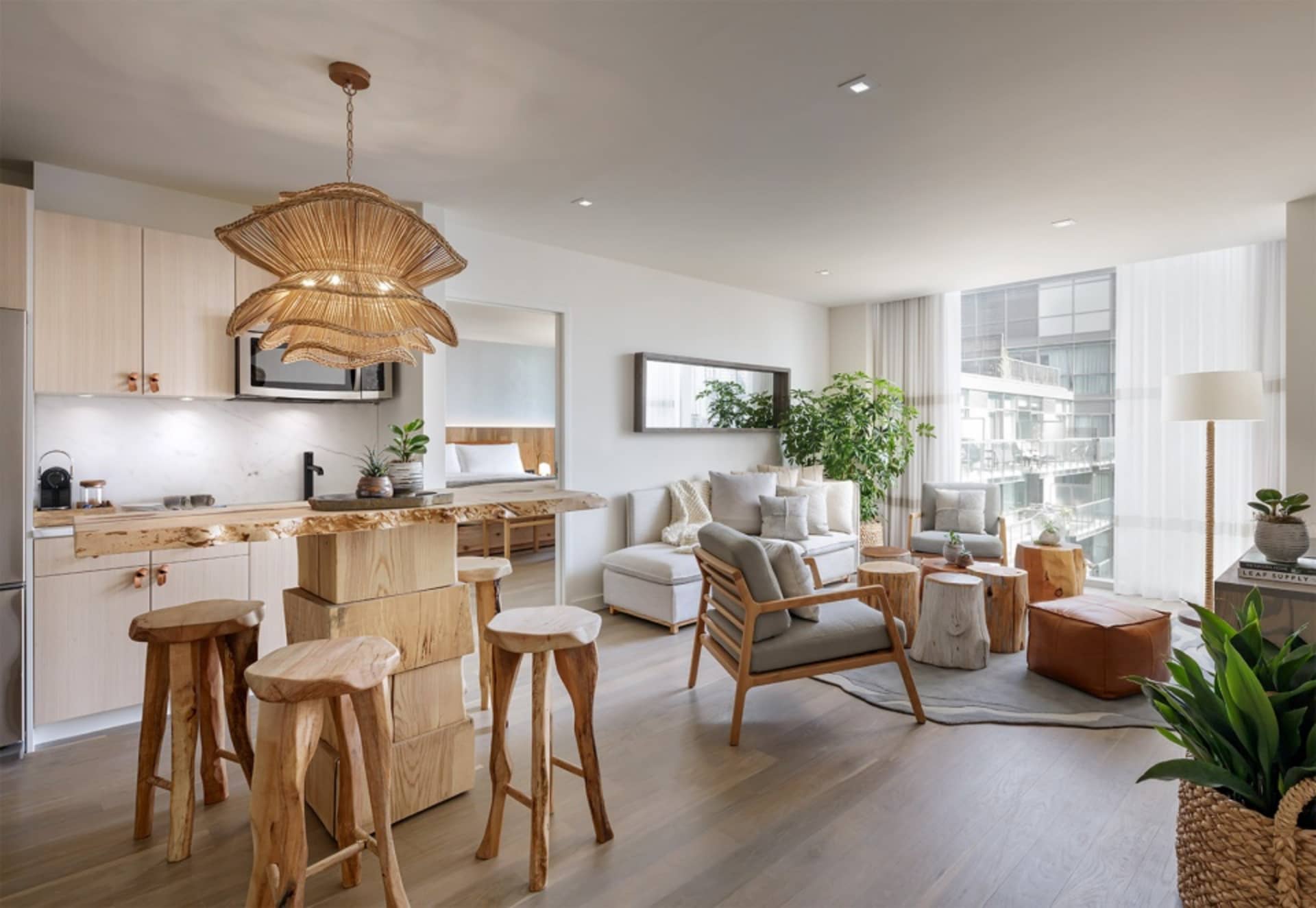 A spacious modern living room featuring wood furniture and decor.