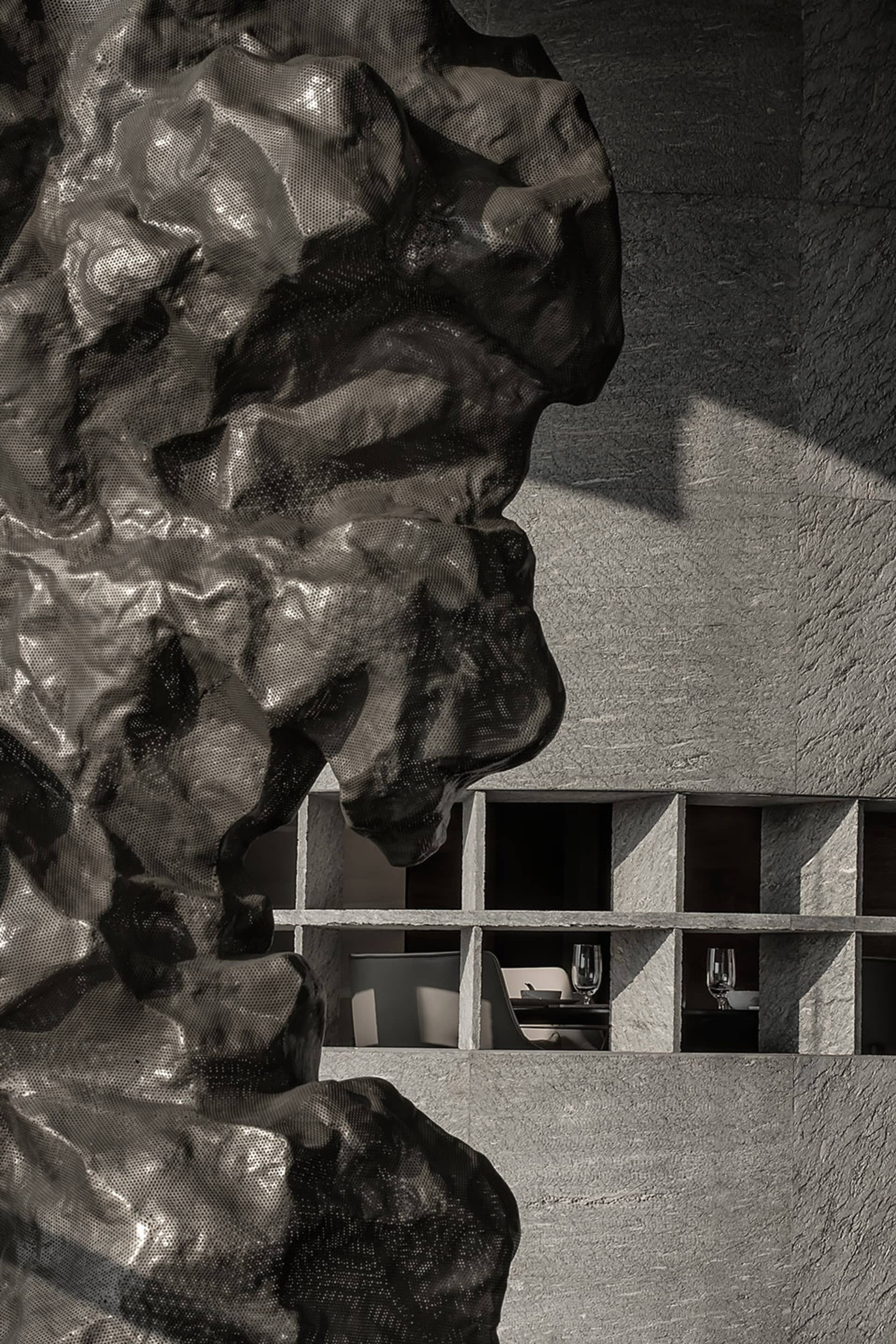 An interior photograph showcasing a modern restaurant with concrete shelving, emphasizing the minimalist design and industria