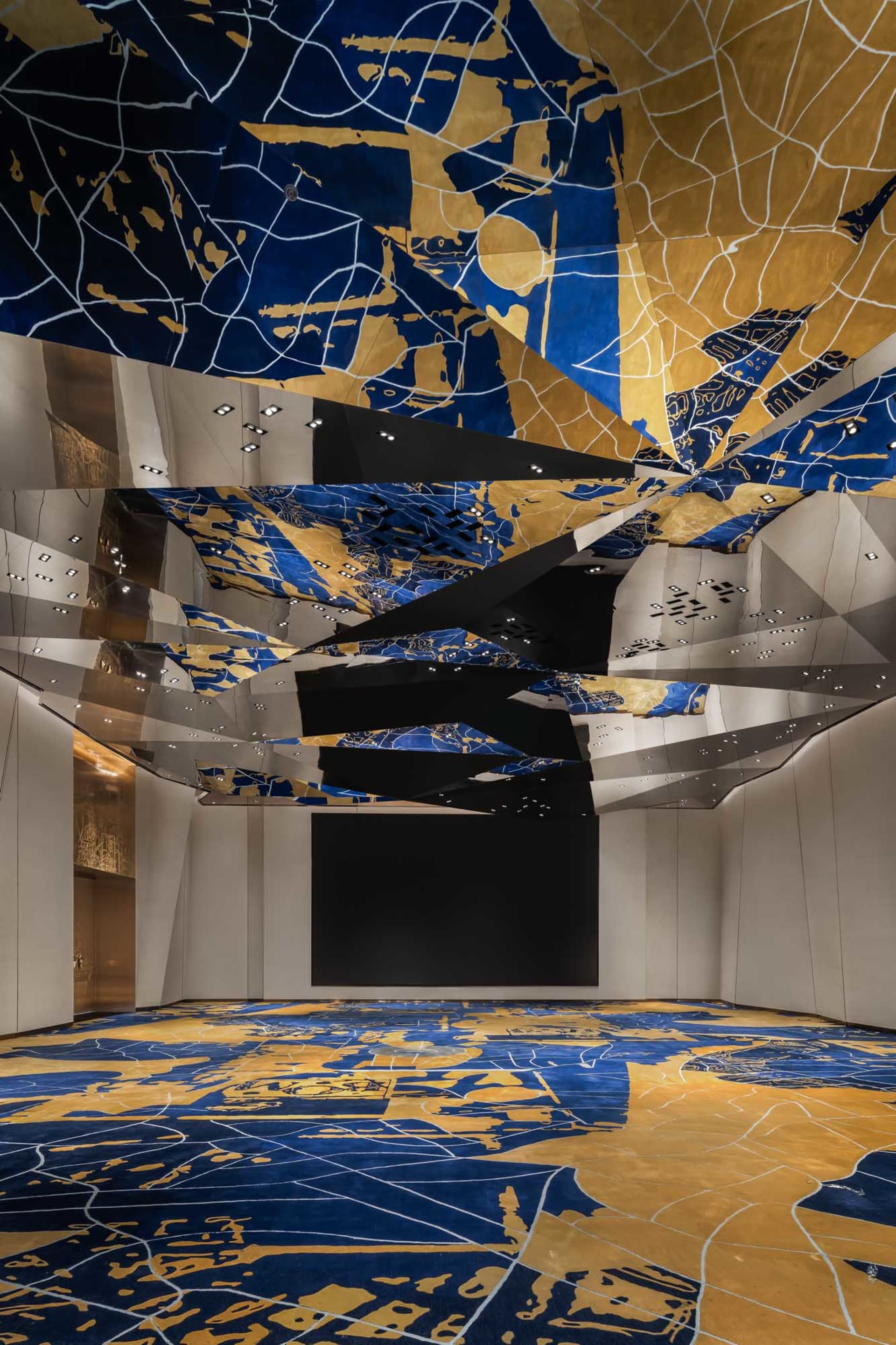 Interior view of a modern conference room with metallic texture ceiling and floor patterns.