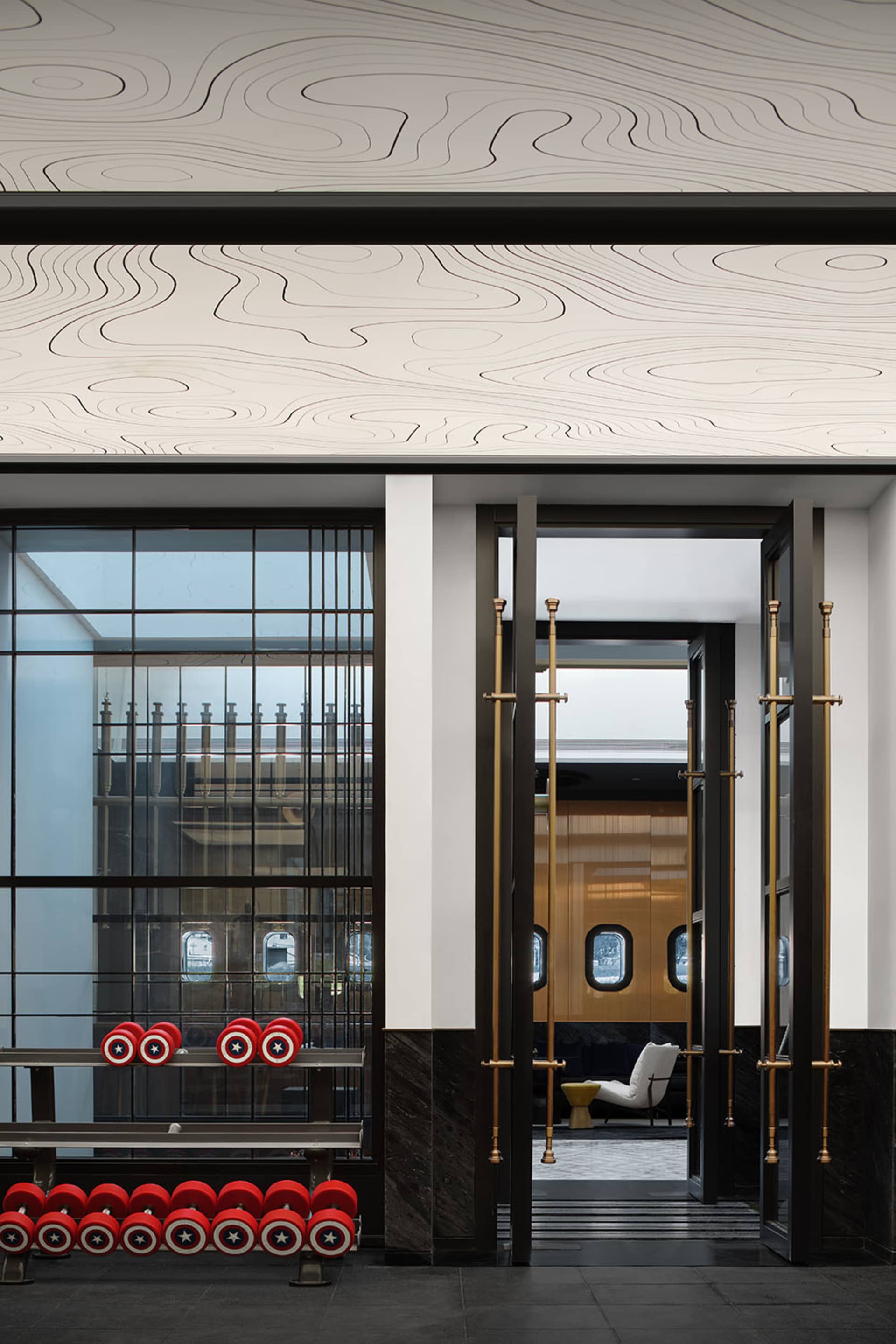 Modern industrial lobby featuring metal, wood, and glass materials.