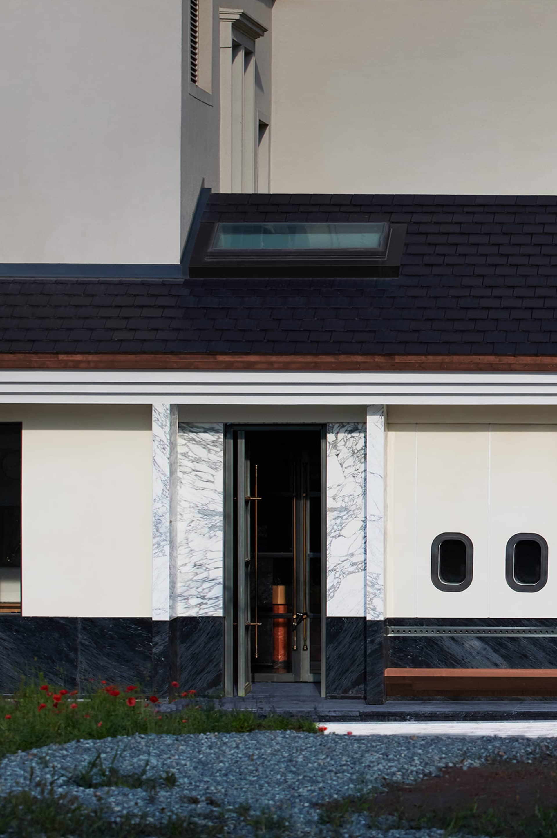 Modern minimalist building entrance featuring marble materials.