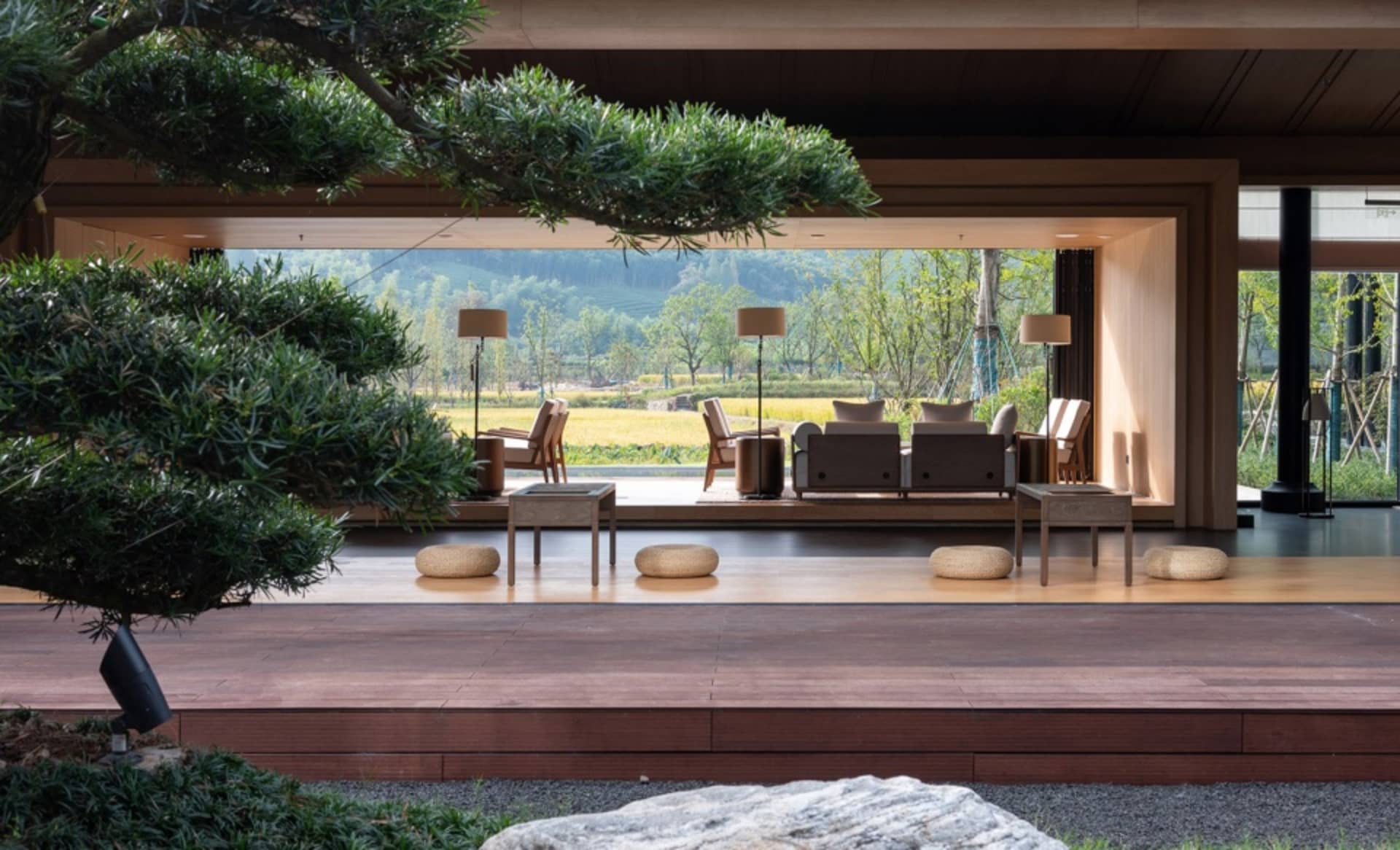 Modern living room featuring wooden and stone materials with a black floor.