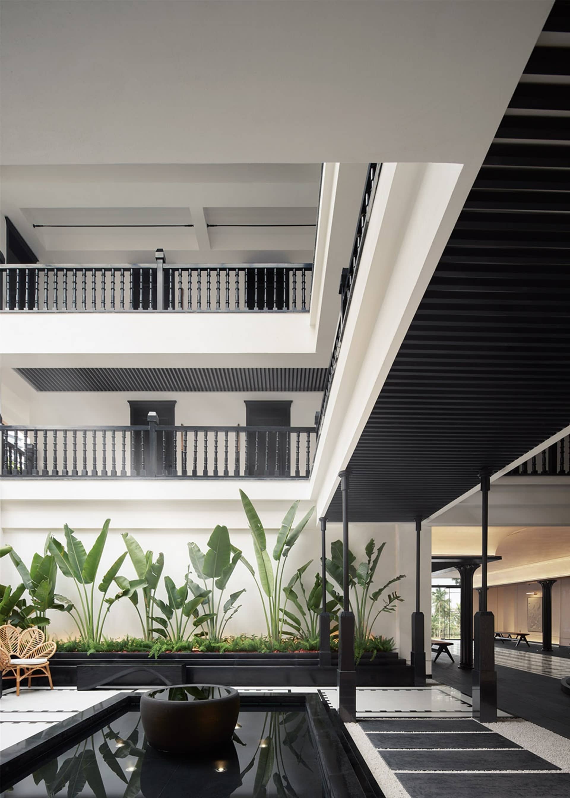 Interior view of a modern hotel lobby featuring contemporary architecture with concrete and wooden materials.