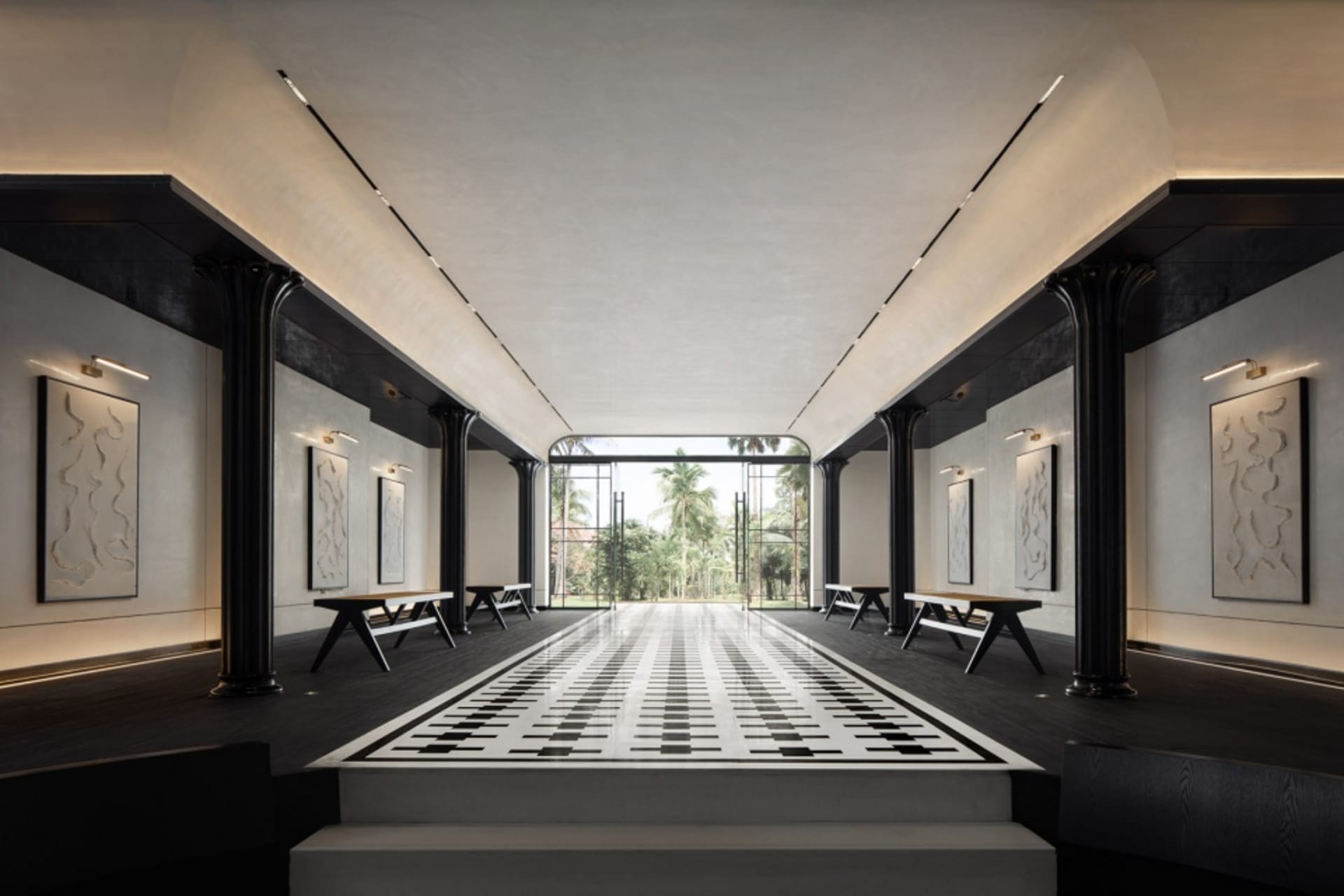 Modern hotel lobby with concrete flooring and minimalist design.