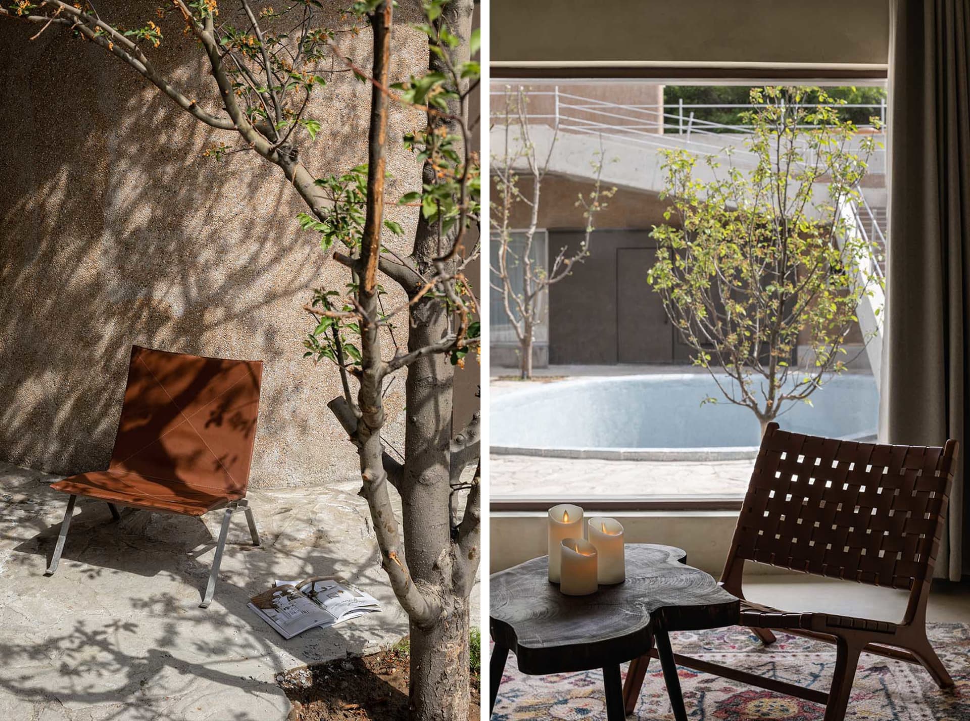 A metal chair and a small table with three candles in a space with a concrete wall and a tree casting shadows on it.