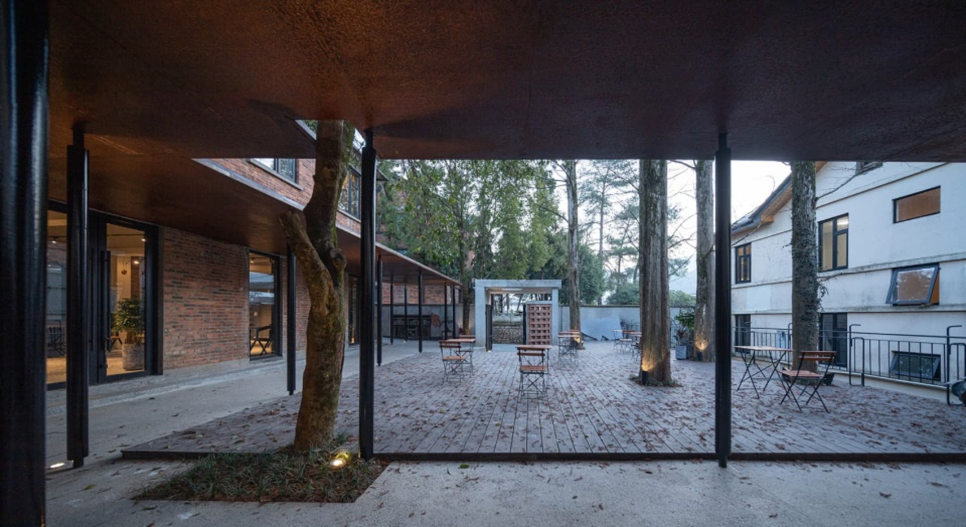 Modern cafeteria patio featuring brick, wood, metal, and glass materials