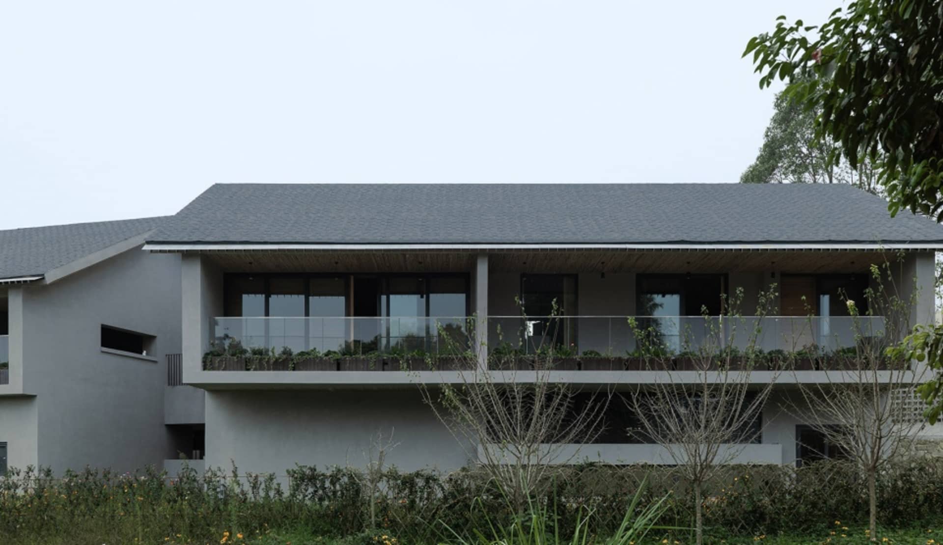 Modern residential house with concrete and glass exterior.