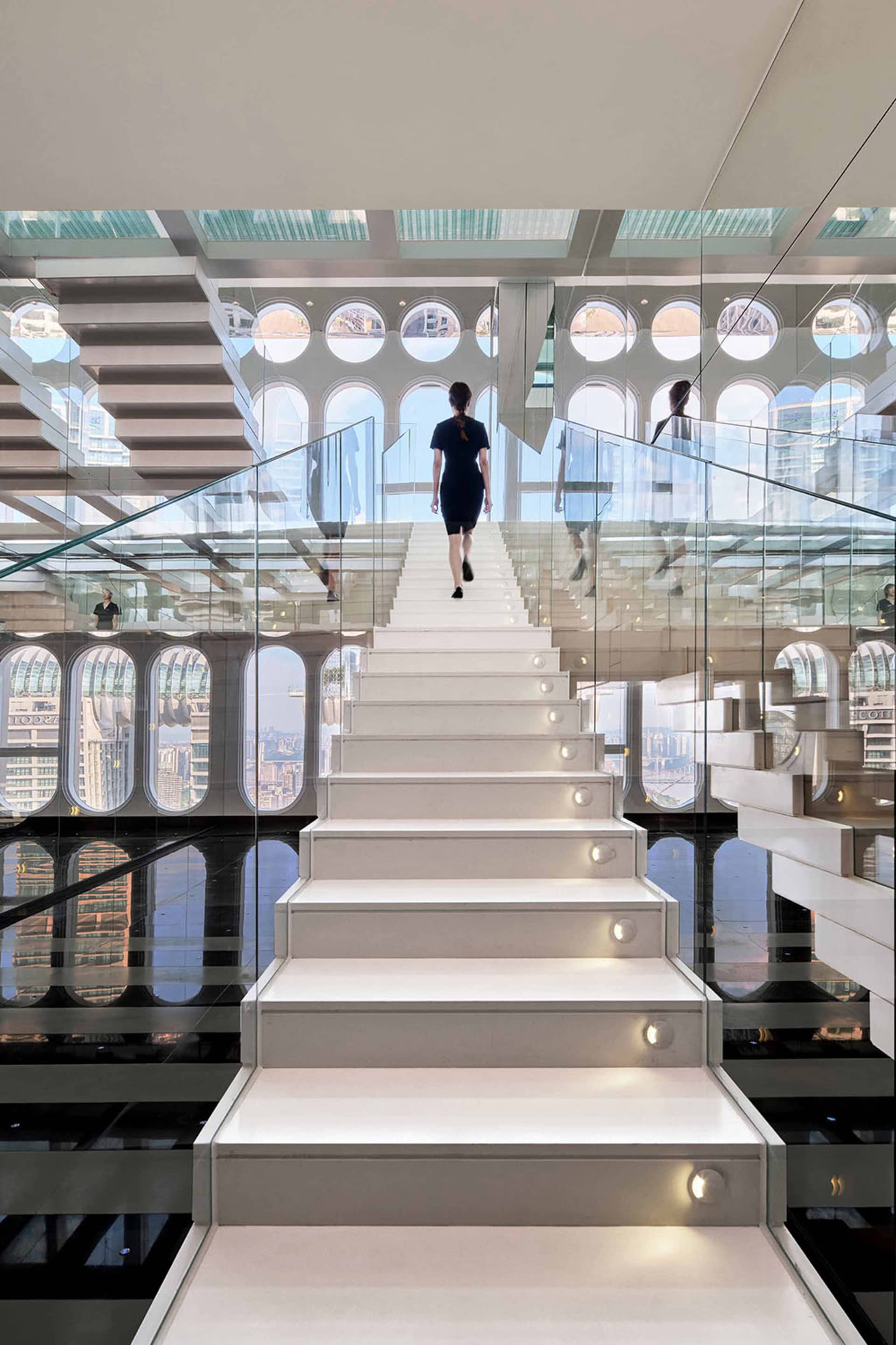 A modern interior space featuring white glass walls and sustainable design elements.