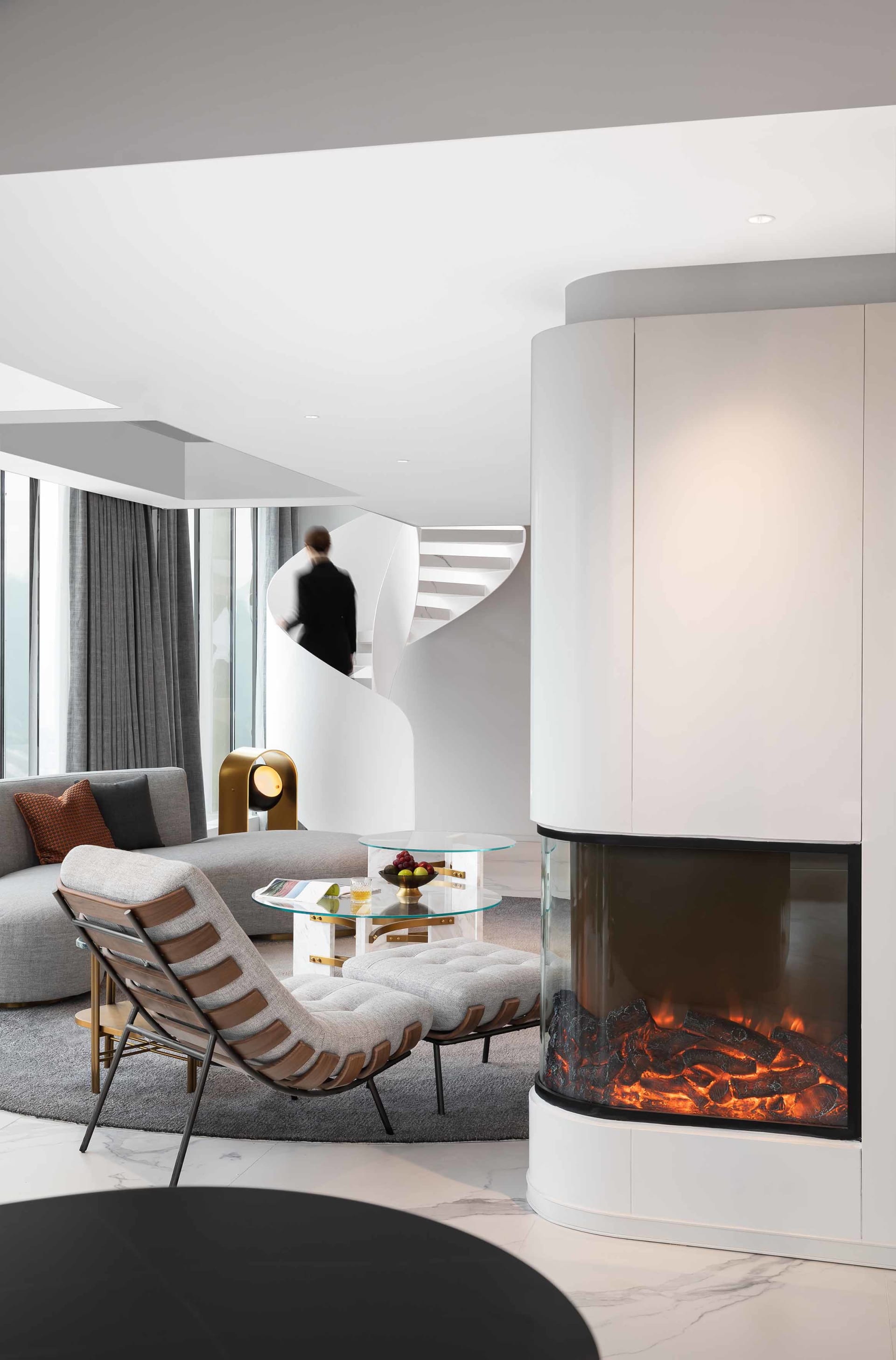 Modern living room featuring a white marble fireplace and contemporary furniture.