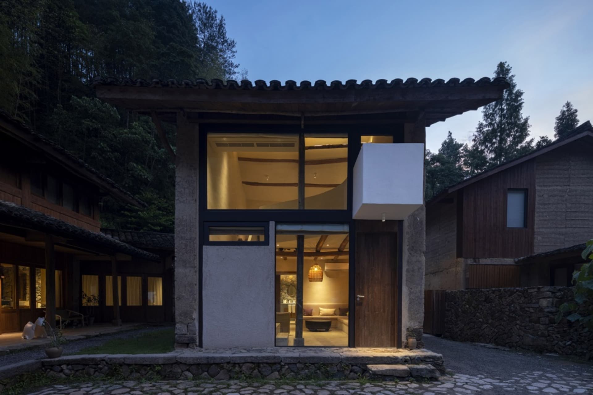 Clay brick residential exterior with traditional architecture and large glass windows.