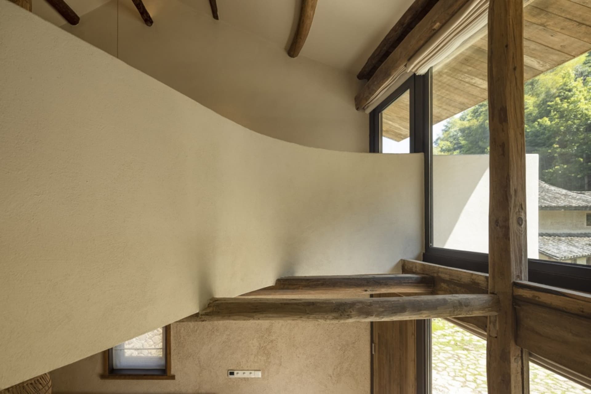 Industrial style staircase with concrete walls and wooden beams