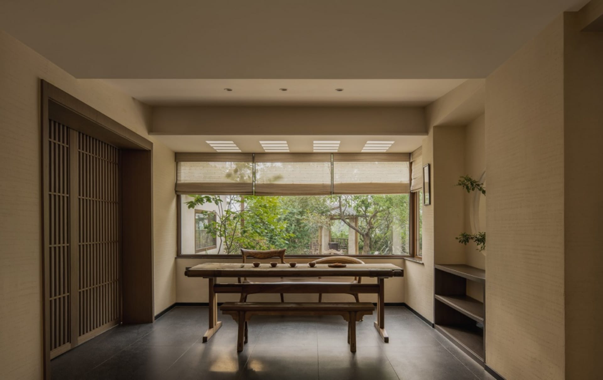 A modern living room with a wooden table and seating area.