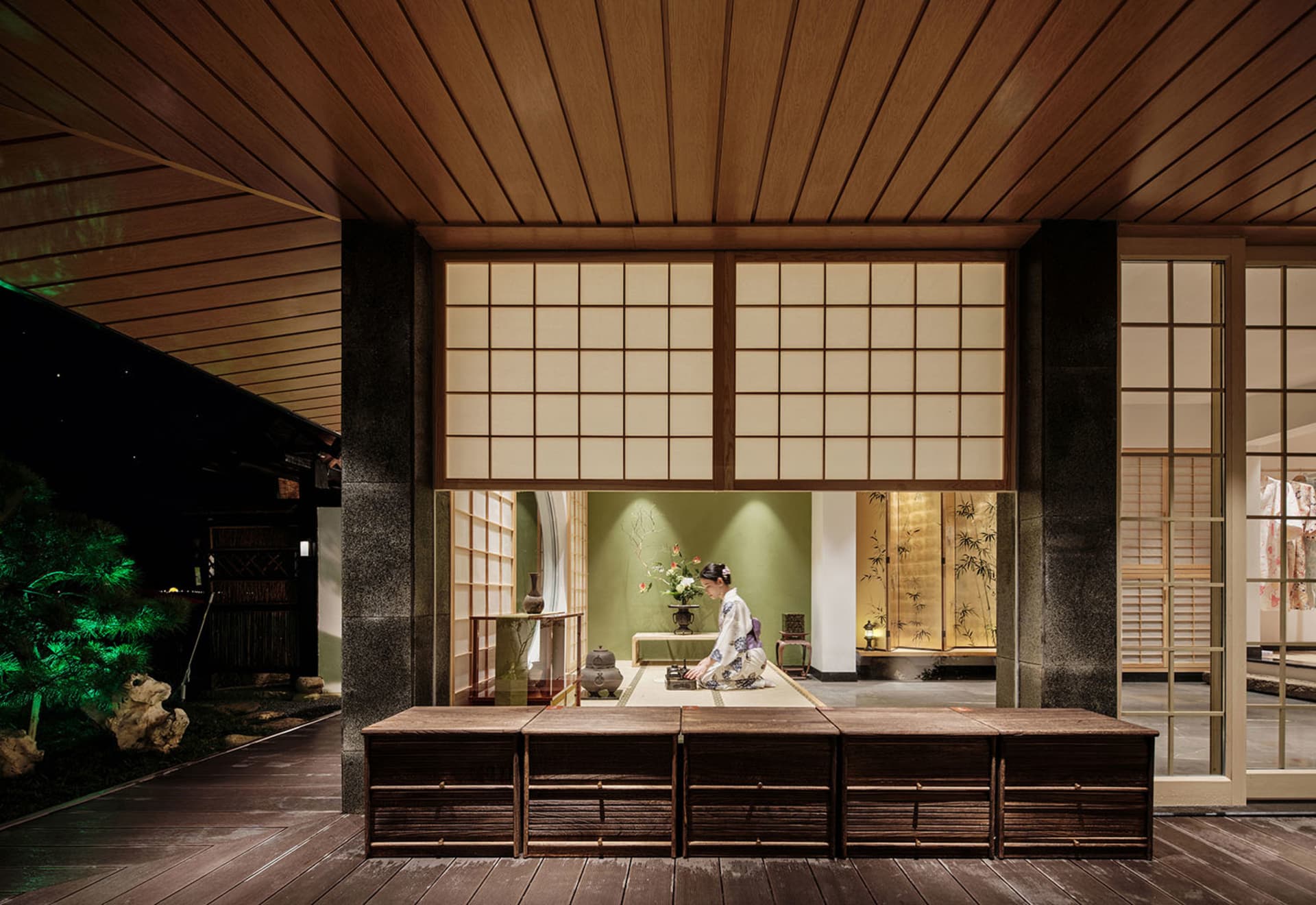 A serene tea house interior with wooden floors, paper windows, and bamboo accents.
