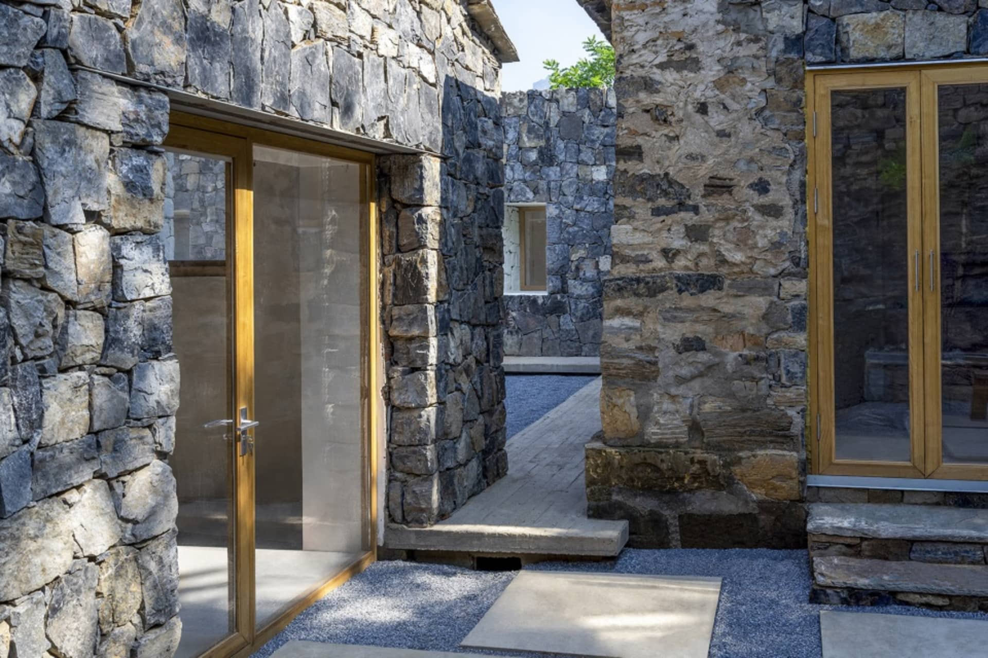 Modern house entrance with stucco walls and glass doors.