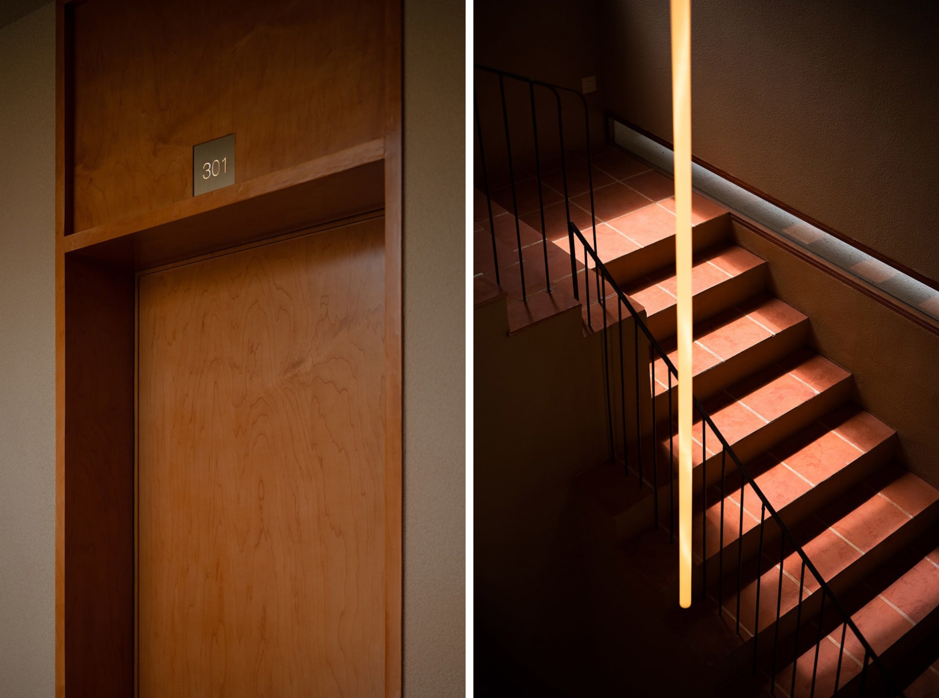 Modern staircase with wooden steps and black handrails.