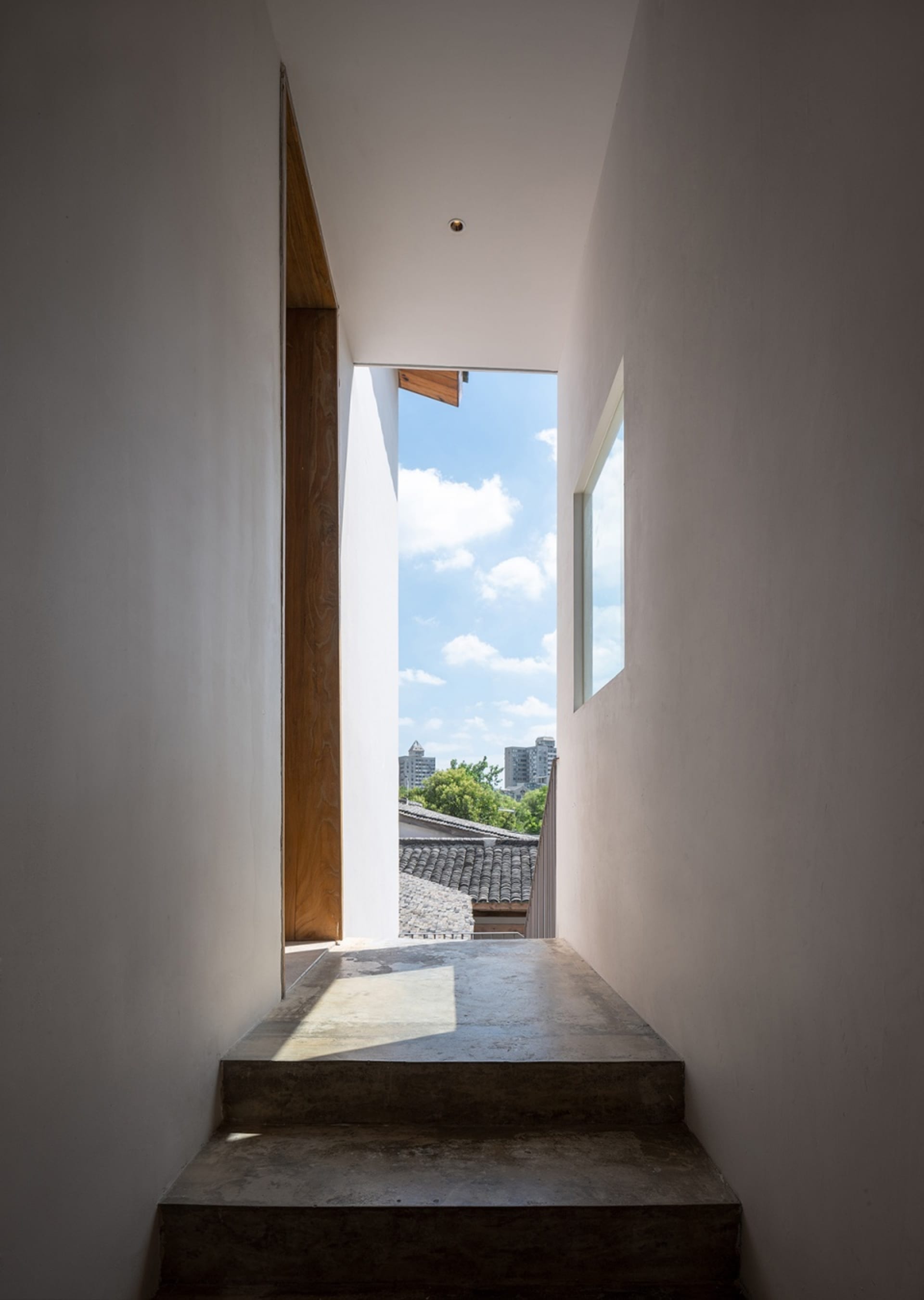 Modern interior design featuring minimalist concrete walls and windows.