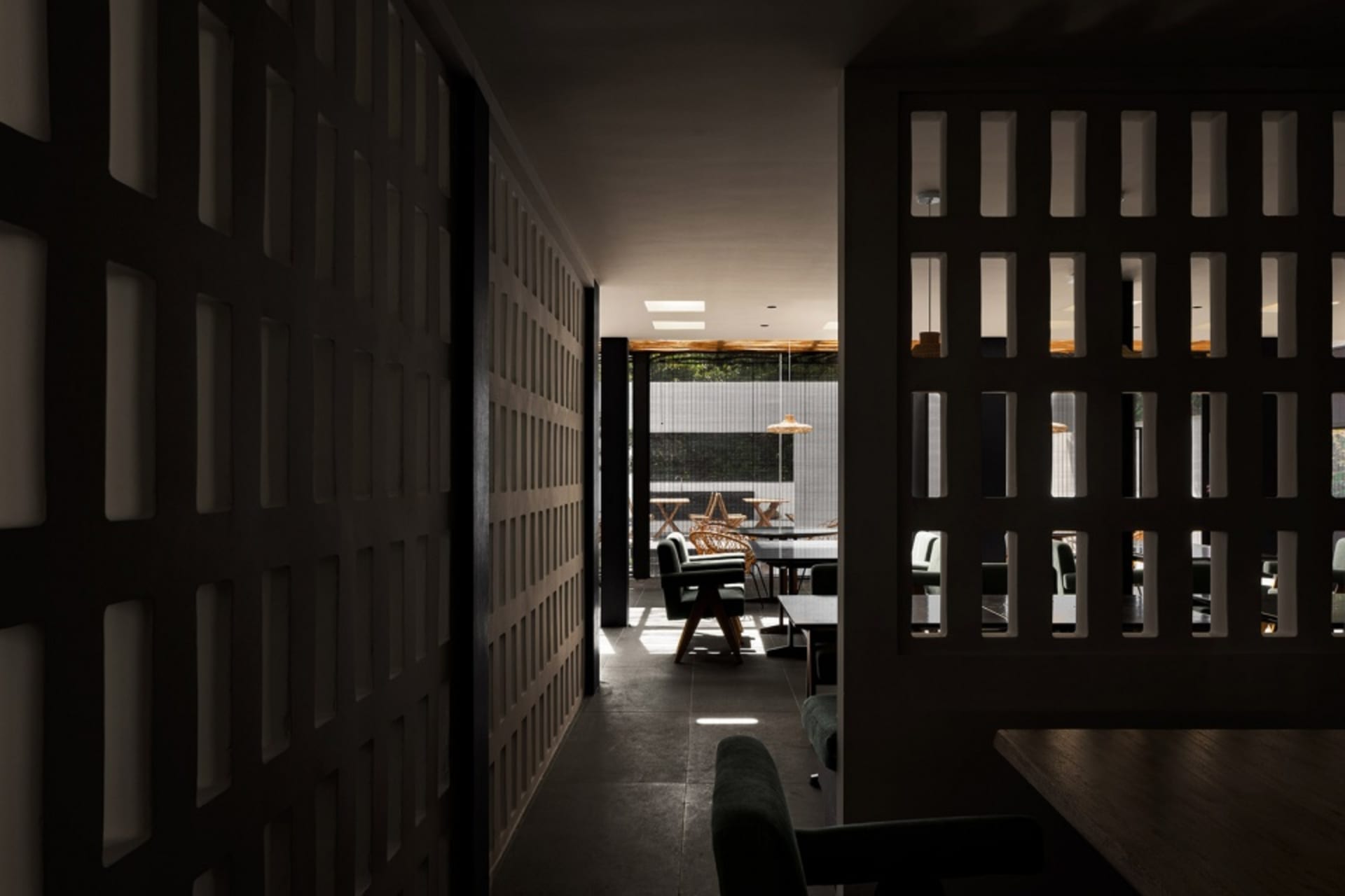 A modern restaurant interior with wooden furniture and a spacious seating area.