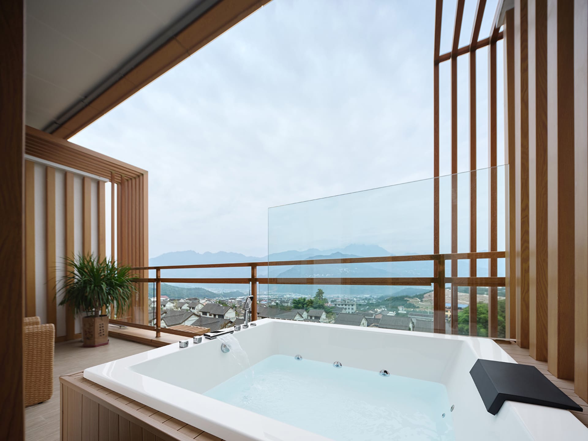 現代浴室內設有玻璃泡澡缸，可眺望城鎮與山景。